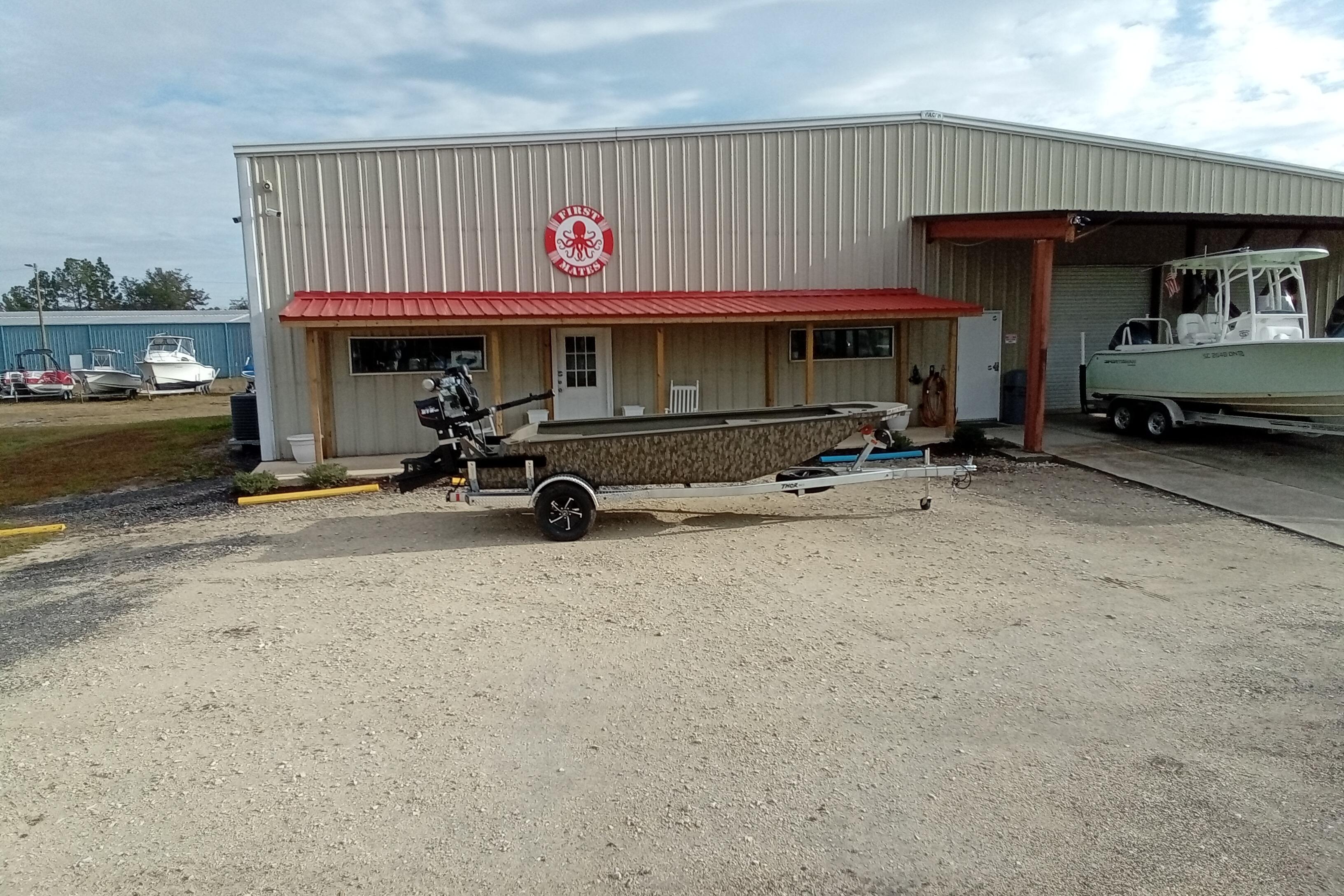 Boat dealership with 2026 Thor 1754 Swamp Hammer on trailer outside.