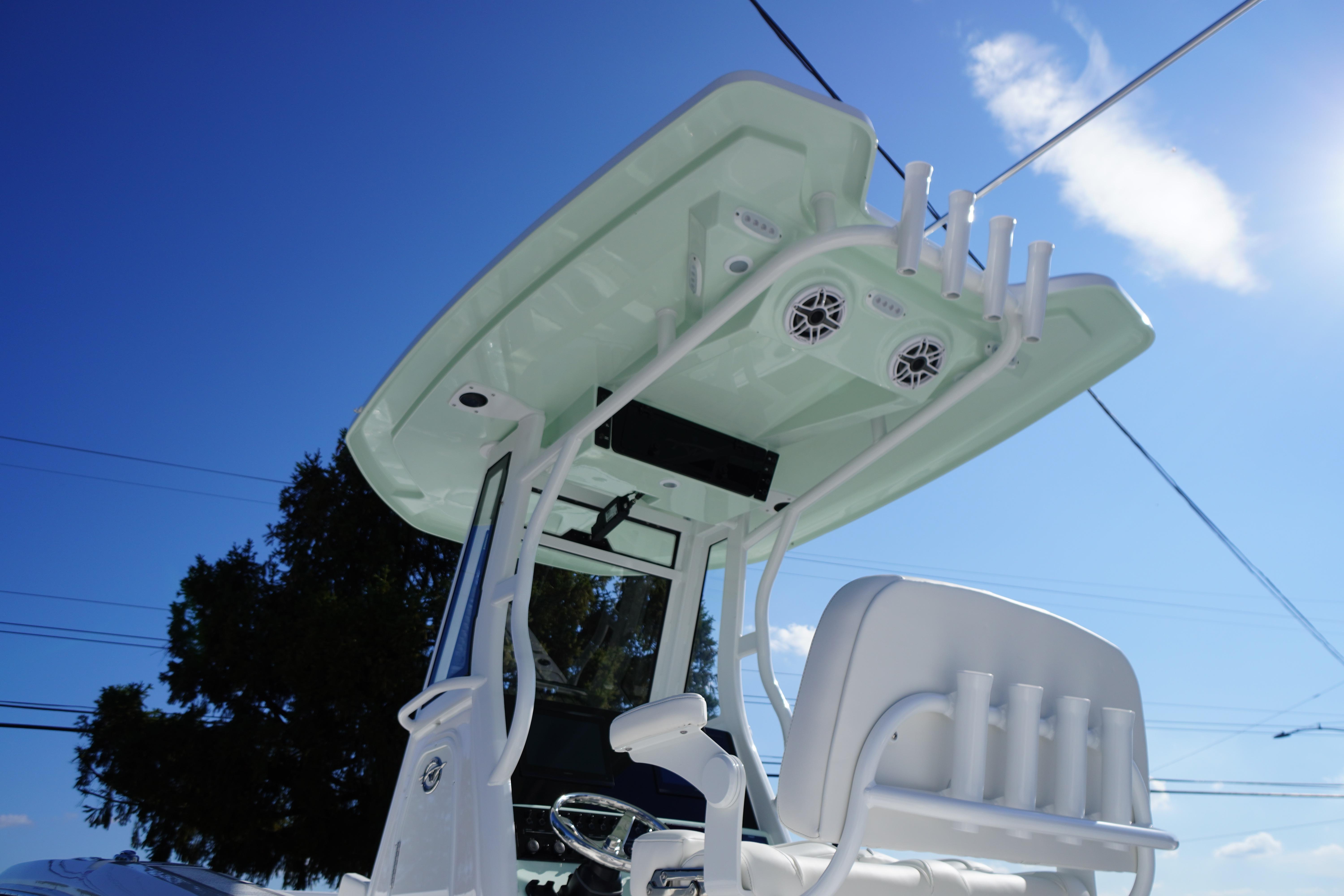 2026 Tidewater 272 LXF boat with T-top and rod holders under clear blue sky.