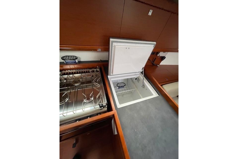 2018 Beneteau Oceanis 45 yacht kitchen with stove and open fridge.