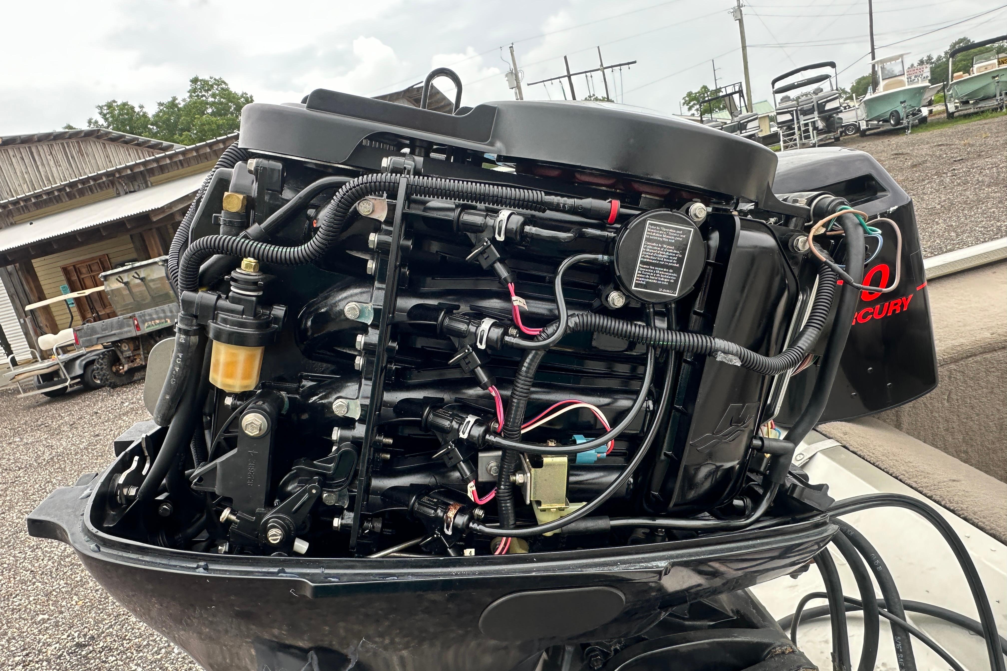 Close-up of a Mercury outboard motor on a 2002 Fisher 1710 boat.