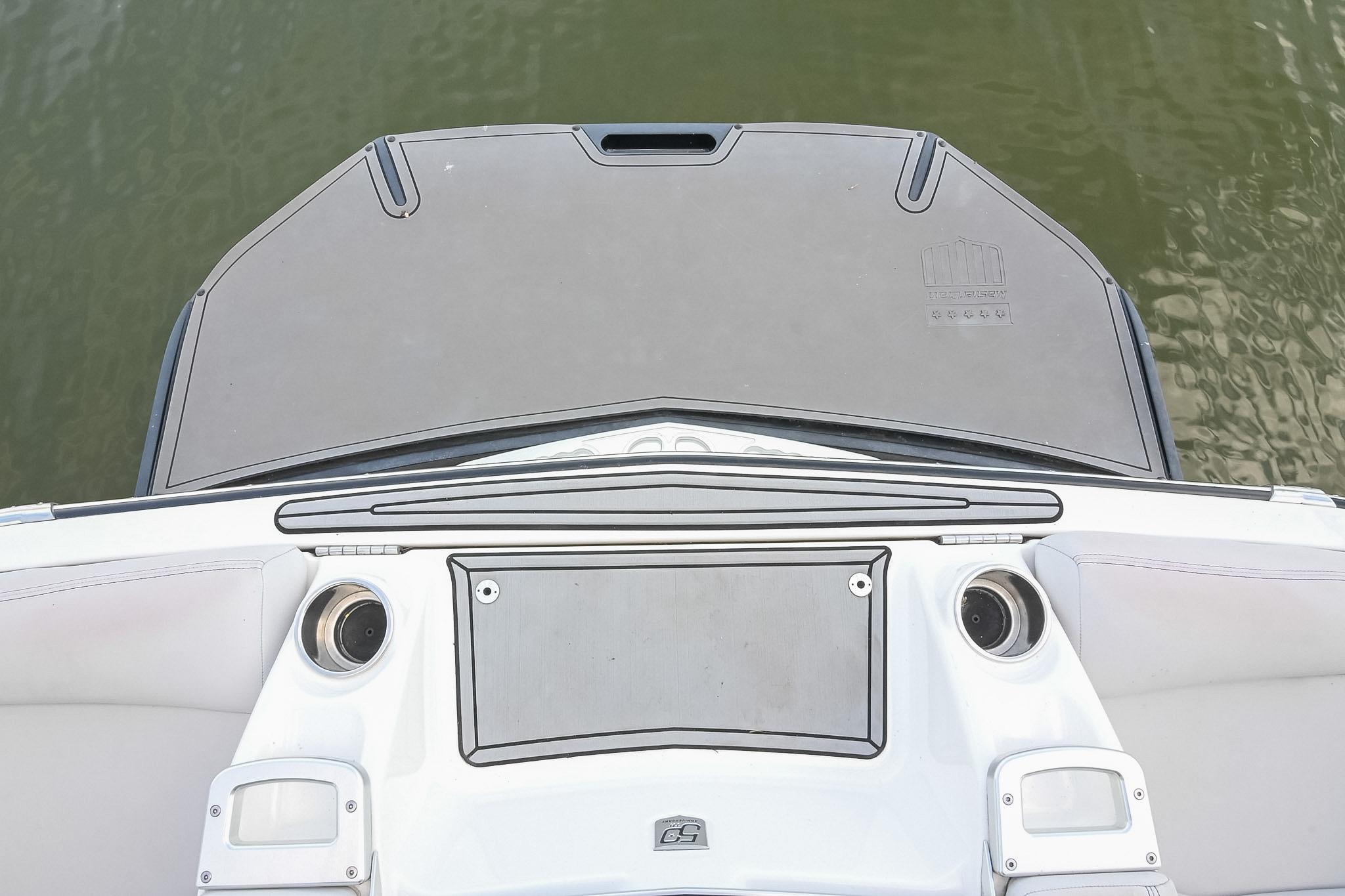2018 MasterCraft X23 boat stern with swim platform and cup holders.