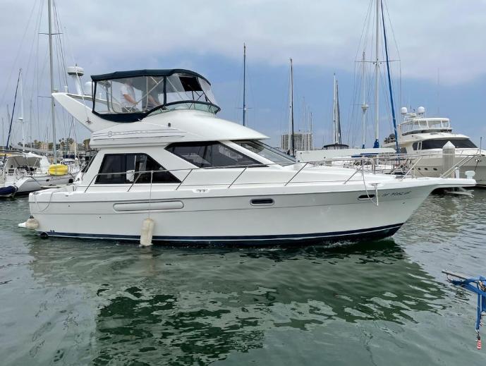 1997 Bayliner 3788 Command Bridge Motoryacht docked in a marina.