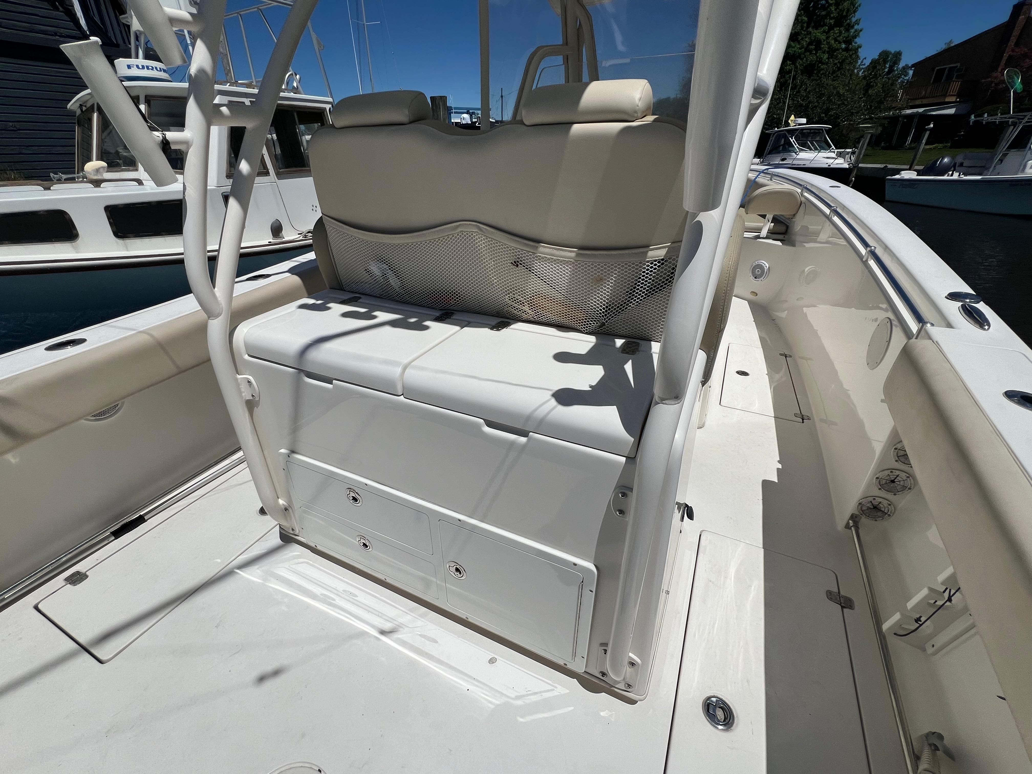 2014 Cobia 296 Center Console boat interior with seating and storage.