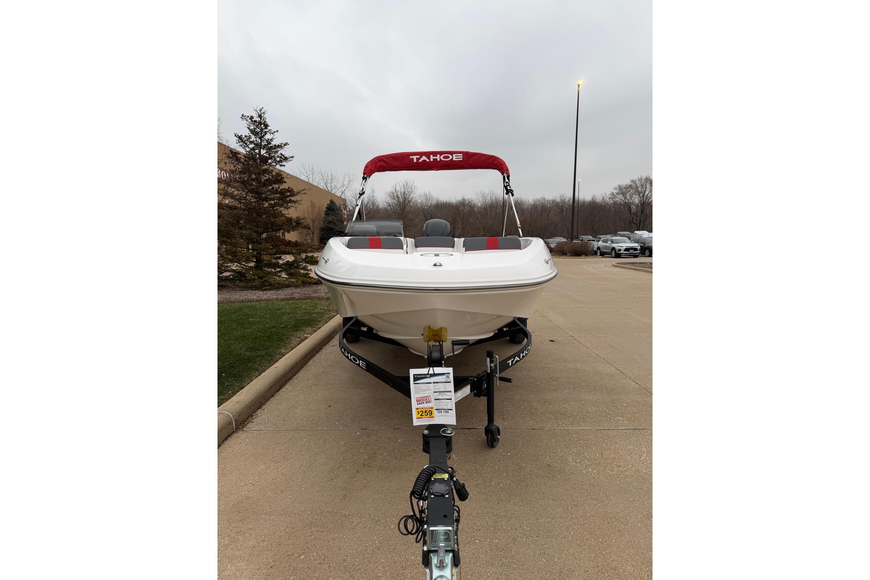 2025 Tahoe T16 boat with red canopy on a trailer in a parking lot.