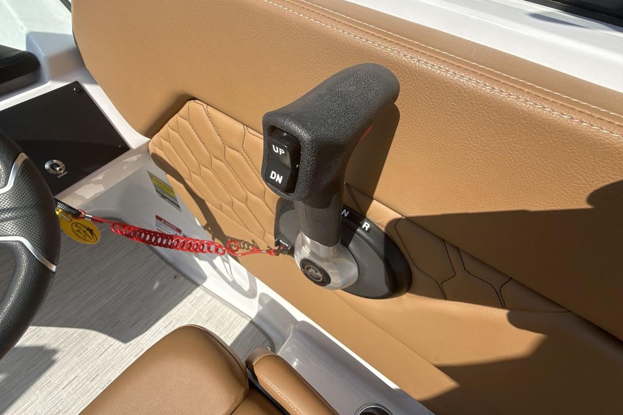 2024 Four Winns H1 OB boat throttle control on tan interior panel.