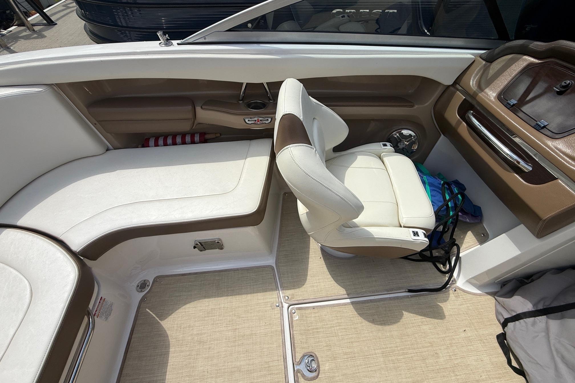 Interior of a 2016 Chaparral 226 SSi Wide Tech boat with beige seating.