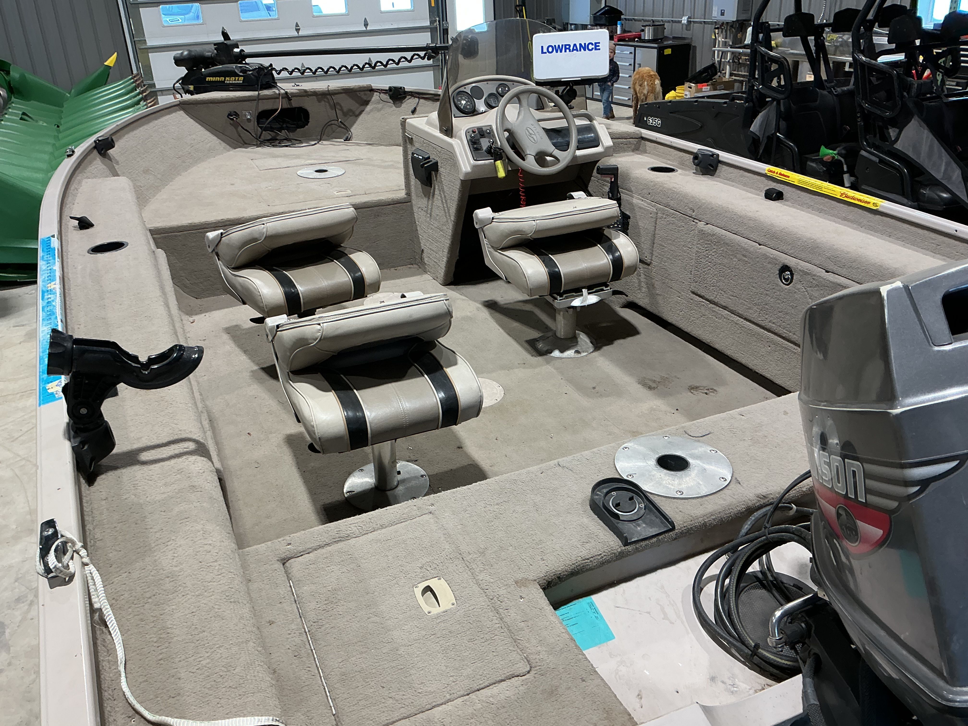 Interior of a 1999 Sylvan EXPEDITION boat with seats and controls.