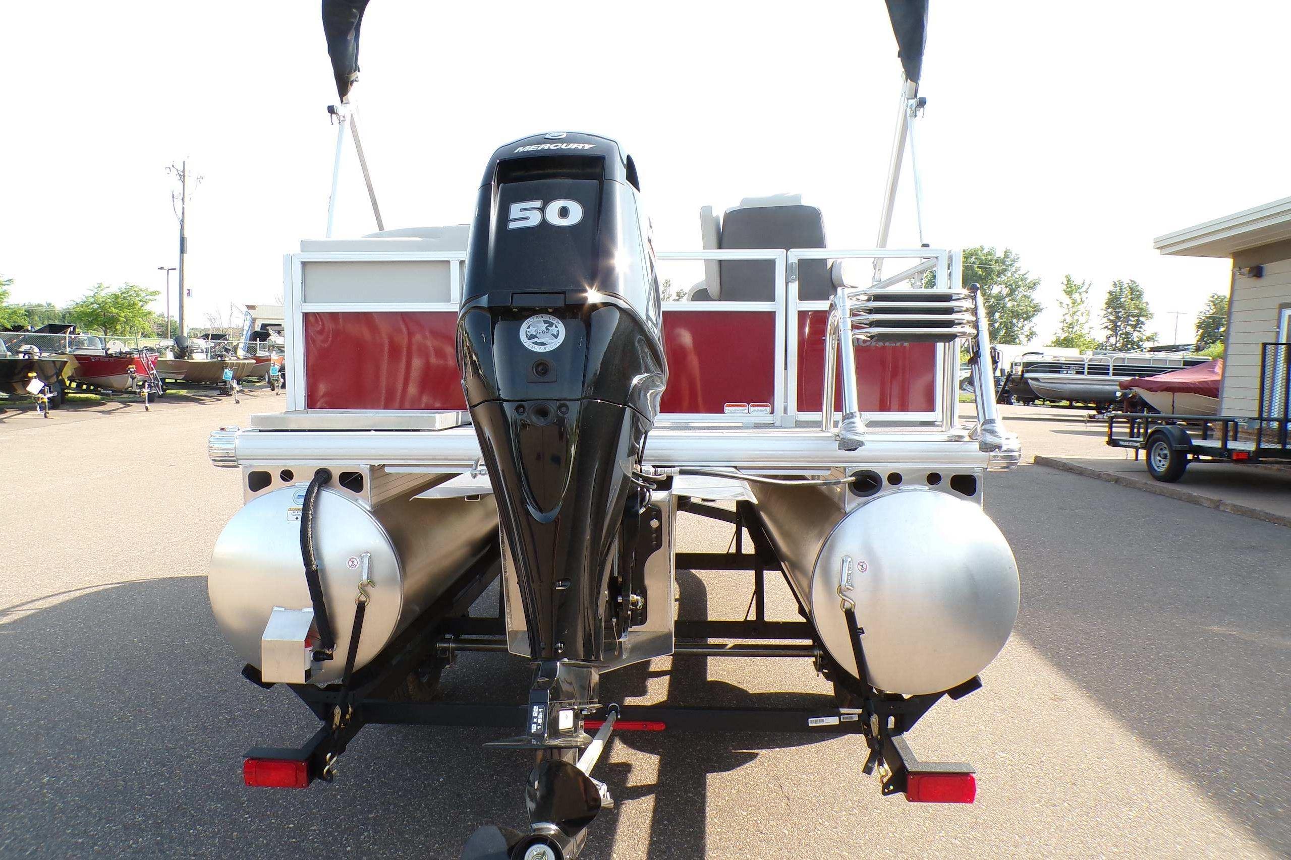 2026 Sun Tracker Bass Buggy 16 XL Select pontoon boat with Mercury 50 engine, rear view.
