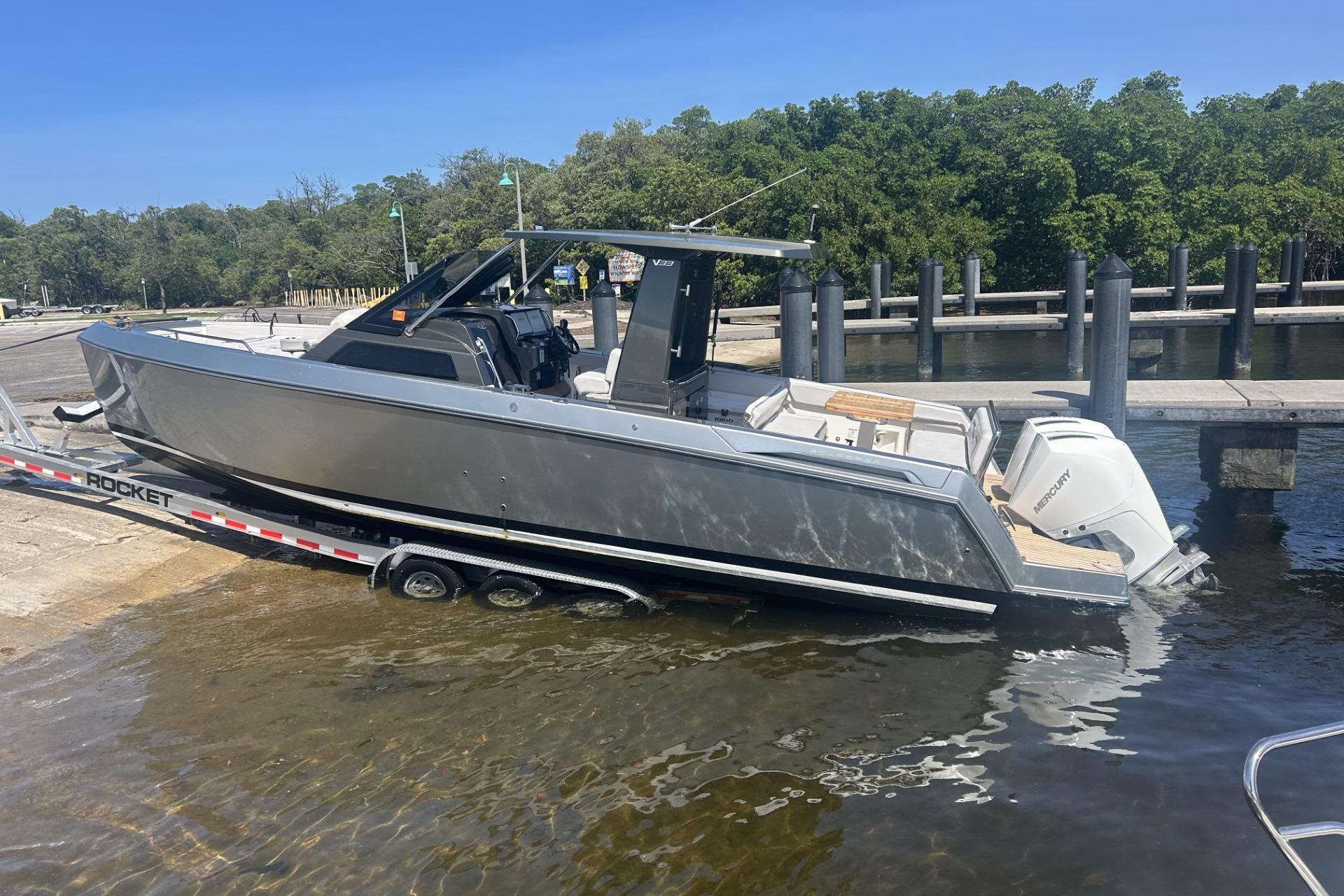 2023 Schaefer V33 boat on trailer at dockside, ready for launch.