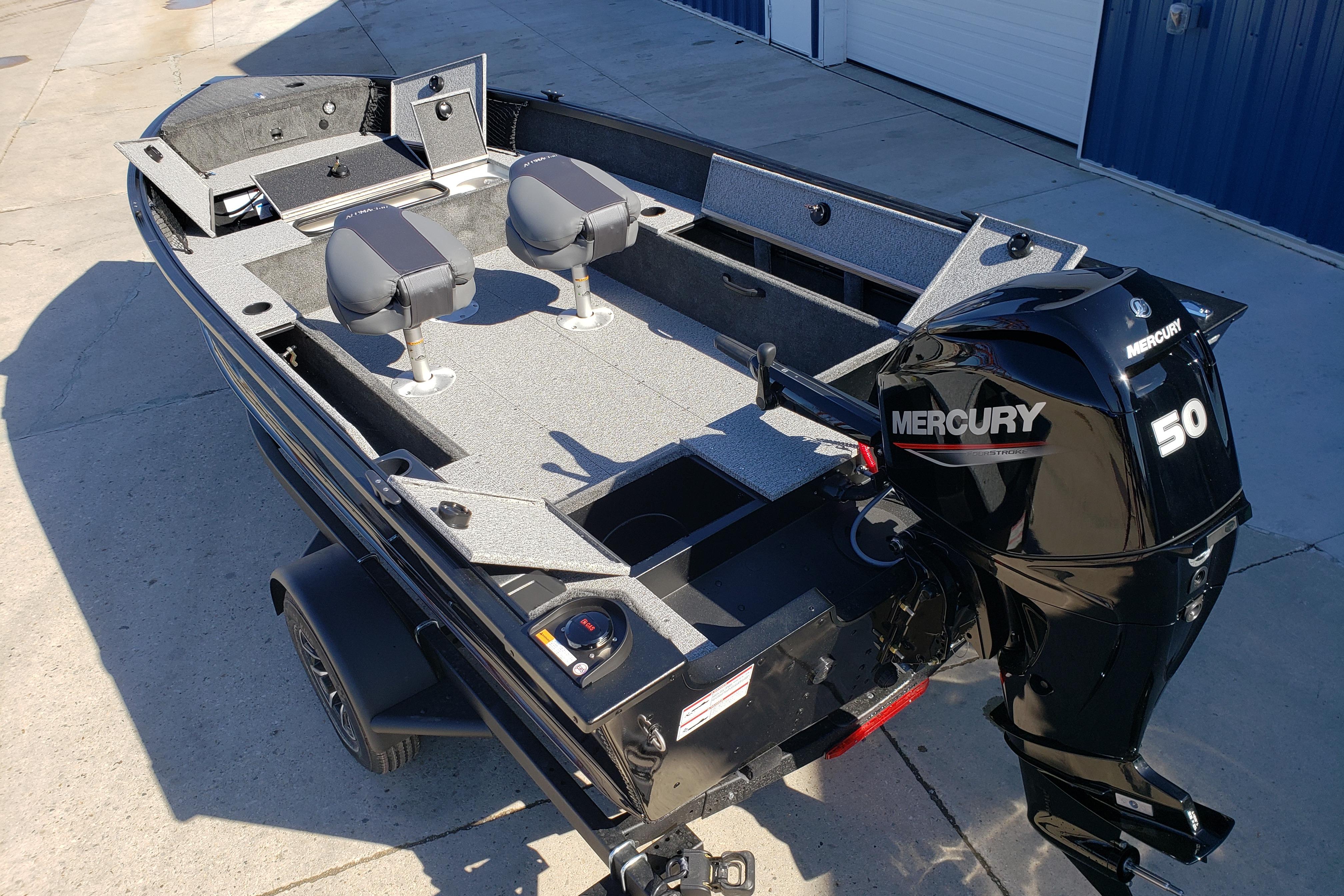 2026 Alumacraft Classic 165 Tiller boat with Mercury 50 engine, parked on concrete.