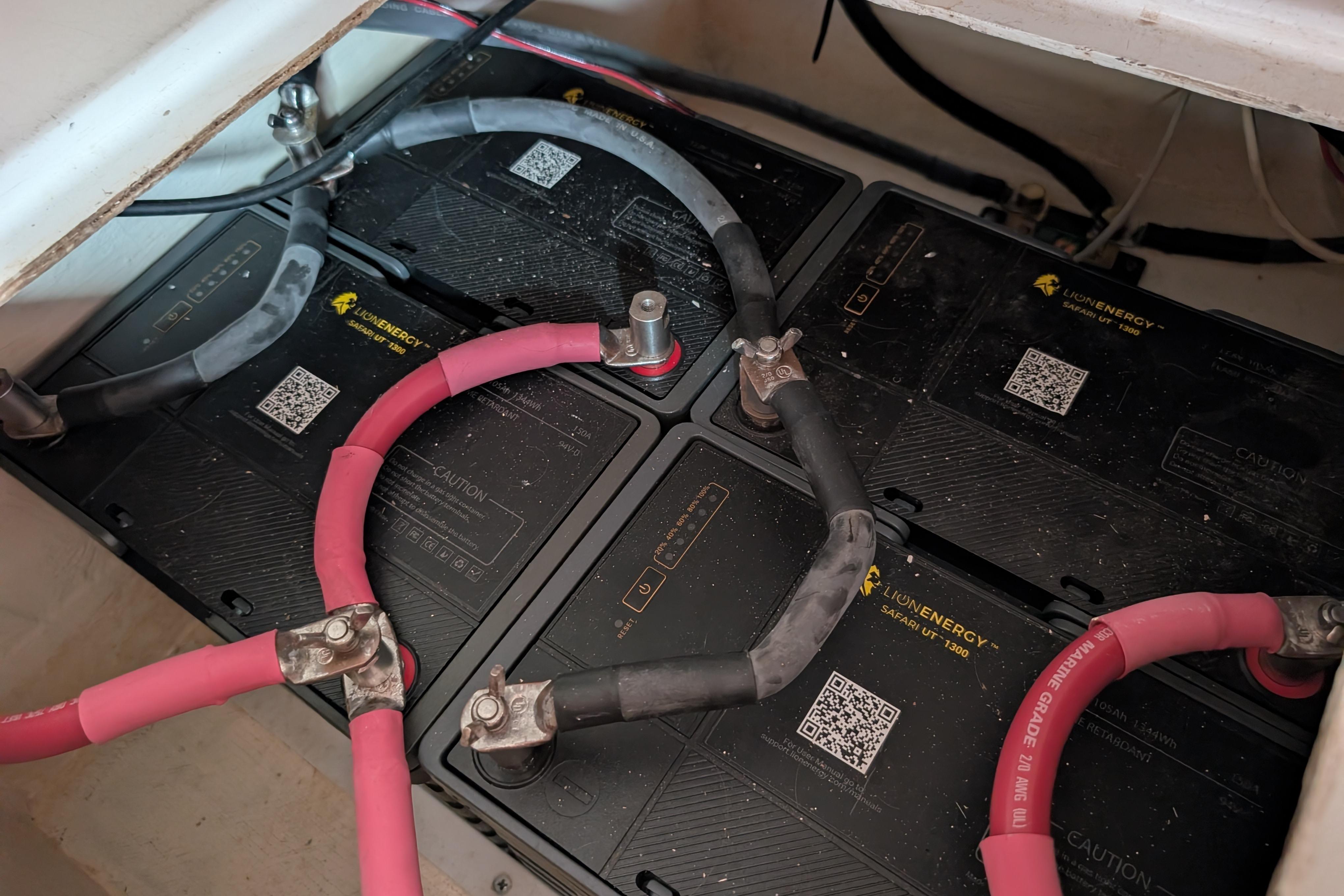 Battery compartment of a 1999 Island Spirit 37 with connected cables.