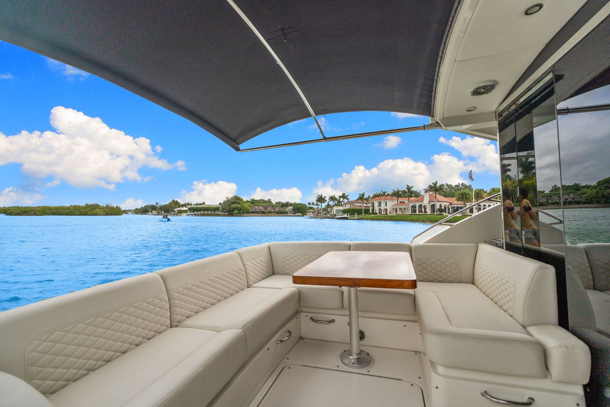 2017 Sea Ray Sundancer 510: Luxurious seating with views of calm water and coastal homes.