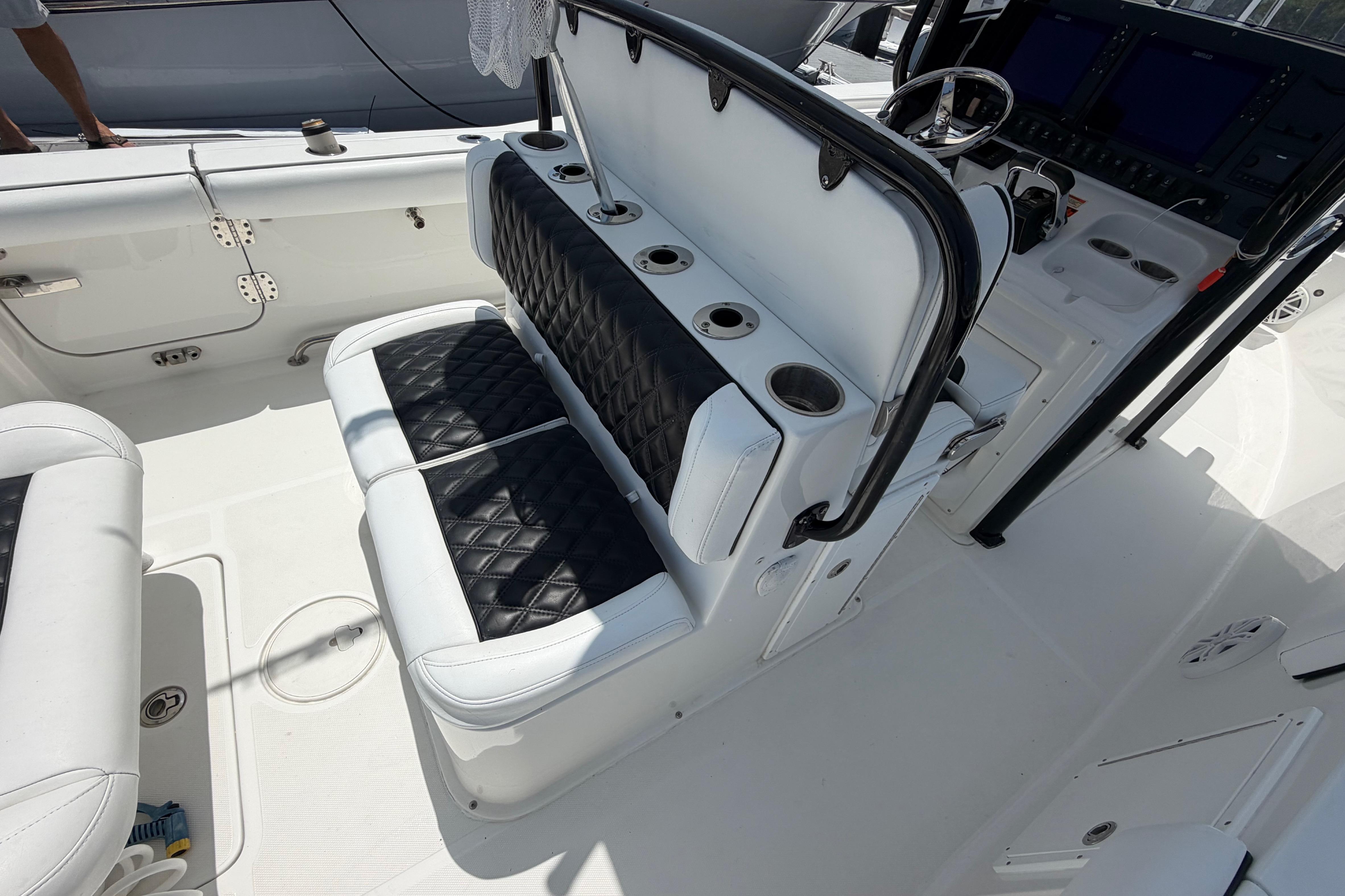 2019 Sea Hunt Gamefish 27 Coffin Box interior with cushioned seating and control panel.