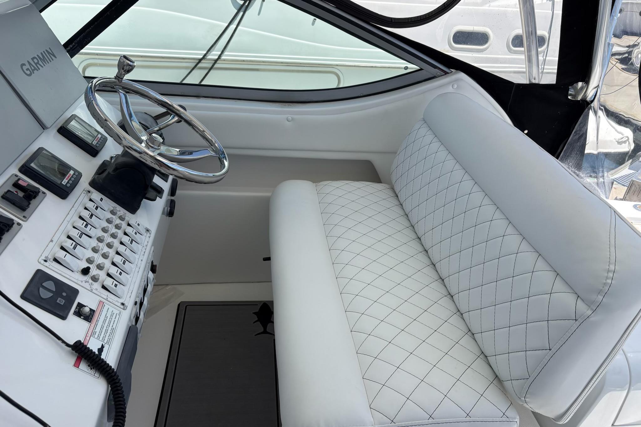 2008 Stamas 370 Express helm with white quilted seating and Garmin navigation system.