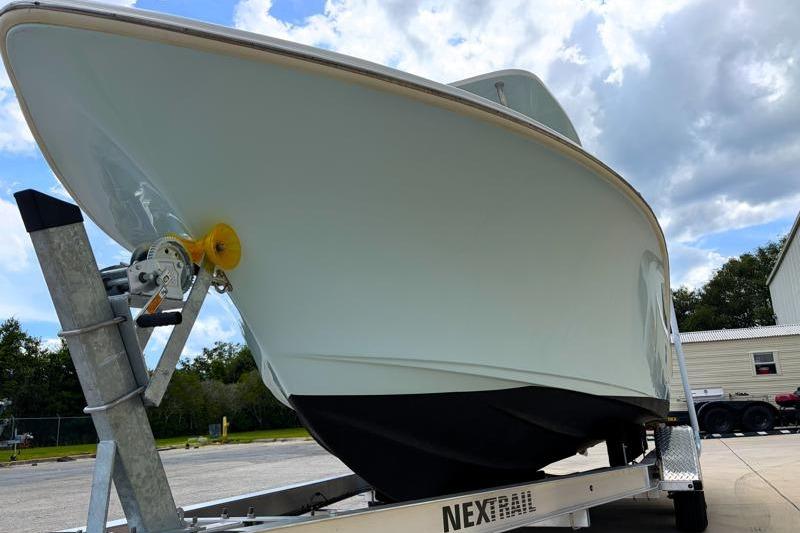 2024 Key West 239 FS boat on trailer under cloudy sky.