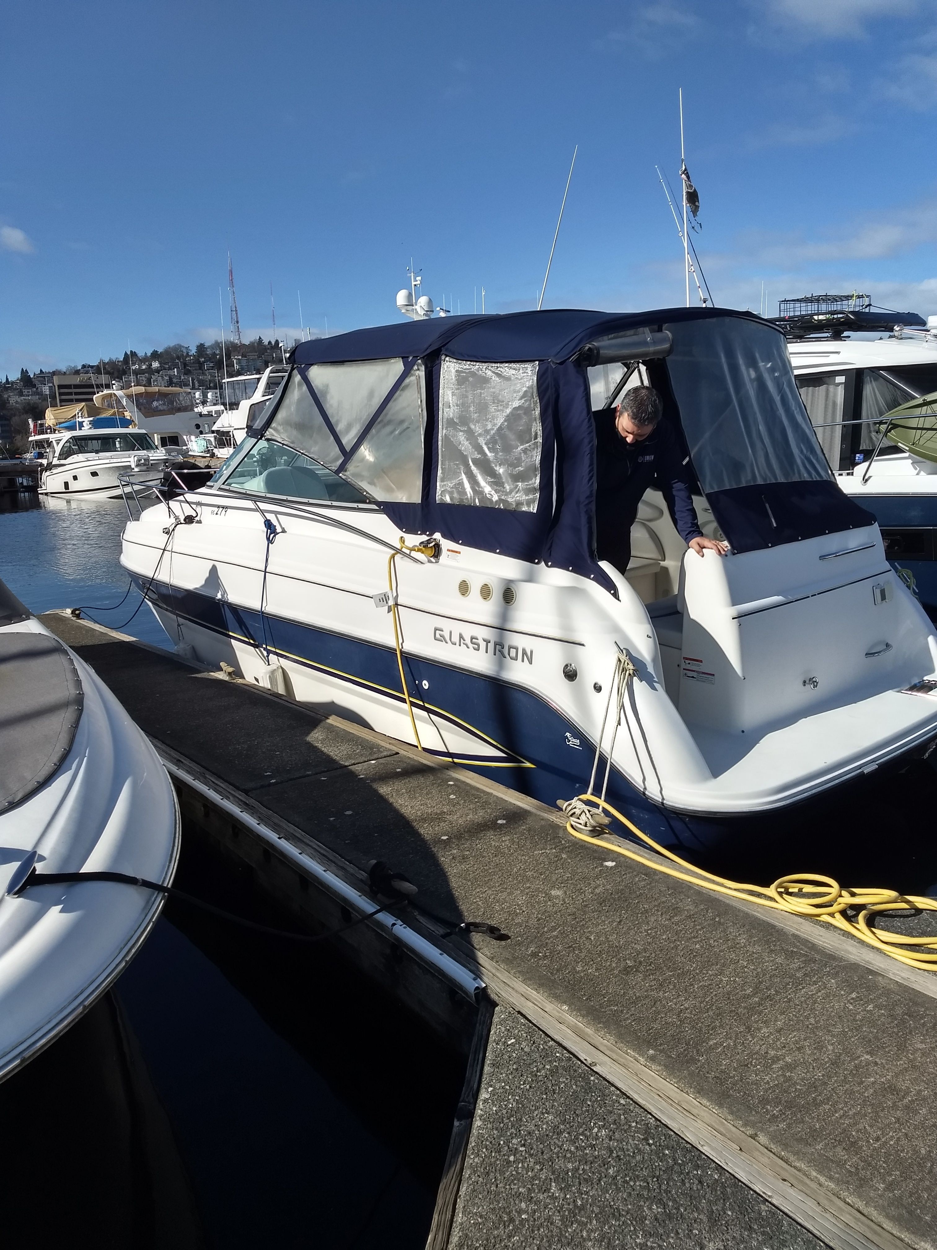 2006 Glastron GS boat docked with blue cover.
