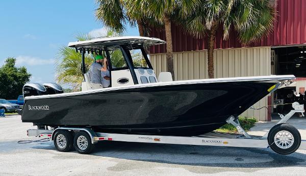 2024 Blackwood 290 boat on trailer outside warehouse.