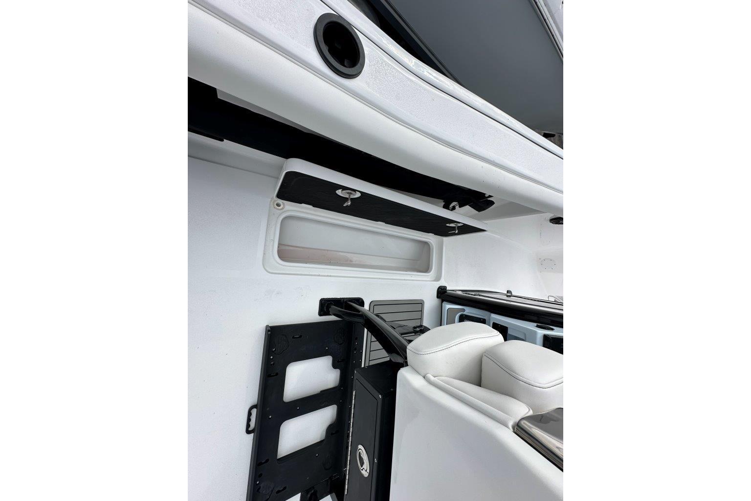 Interior view of 2026 Tidewater 272 LXF boat, featuring sleek white seating and storage compartments.