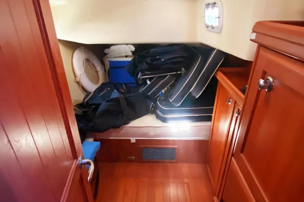 Interior cabin of 2012 Hunter Aft Cockpit 50 yacht with wooden finish and storage.