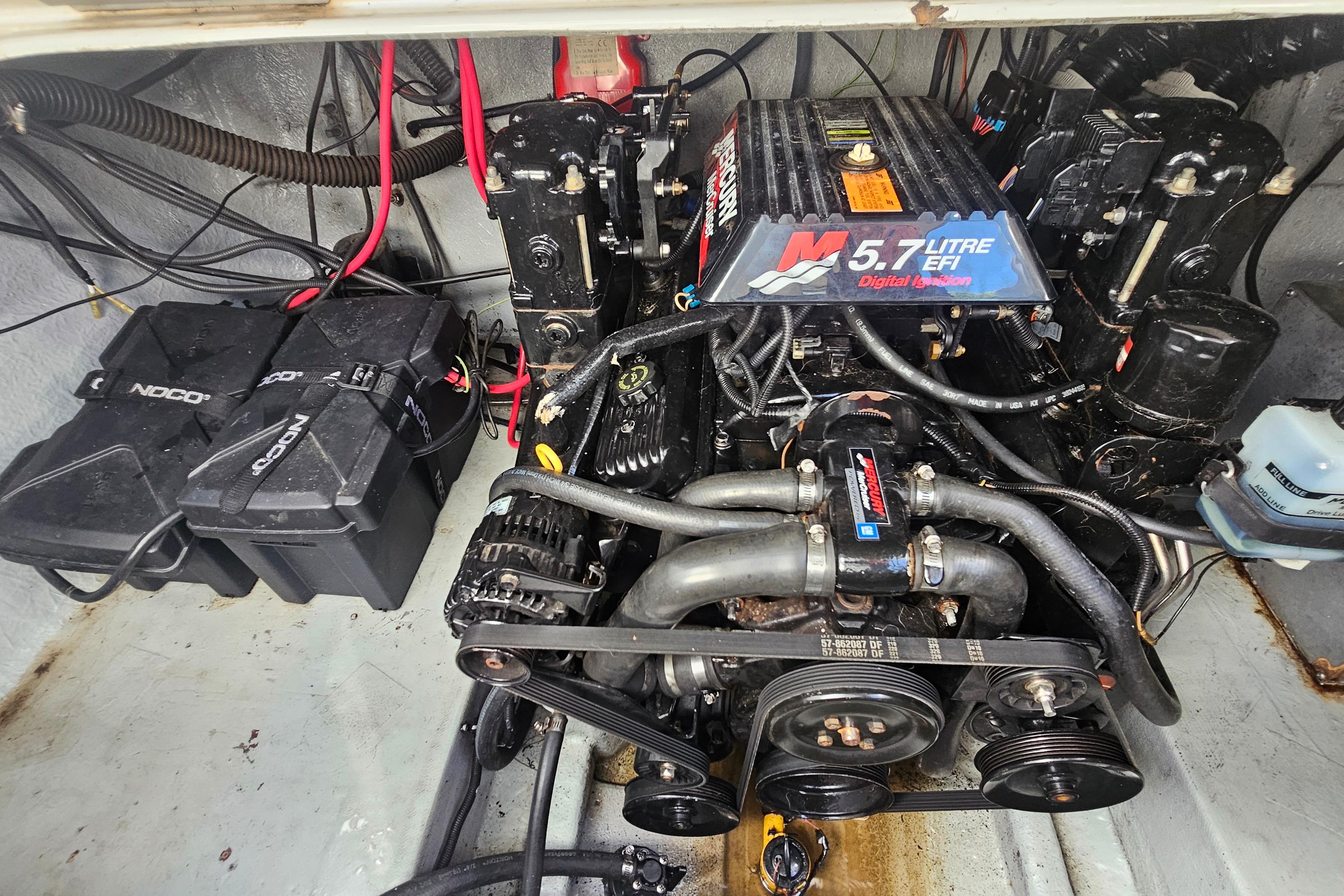 Engine compartment of a 2000 Crownline 242 CR boat with 5.7L EFI engine.
