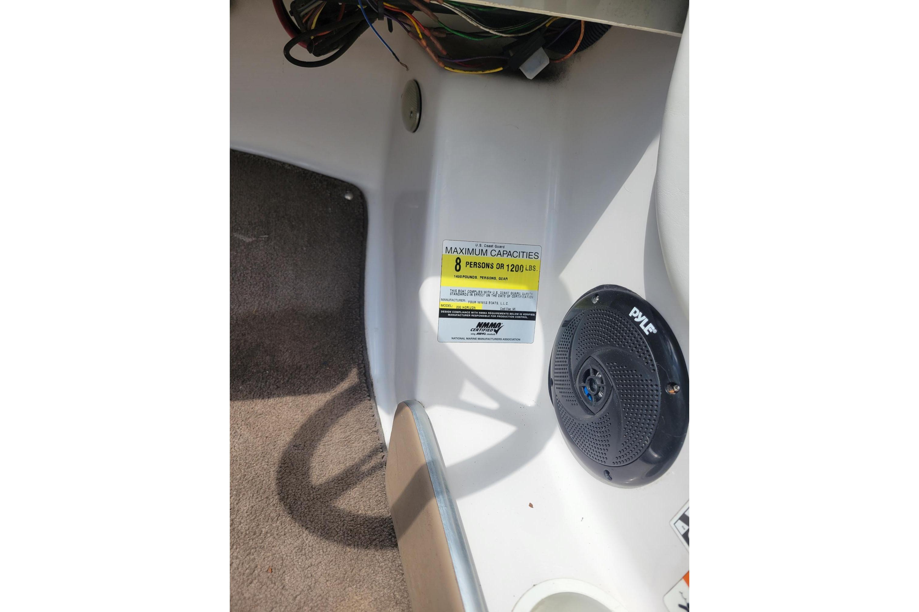 2007 Four Winns 200 Horizon boat interior with capacity label and speaker.