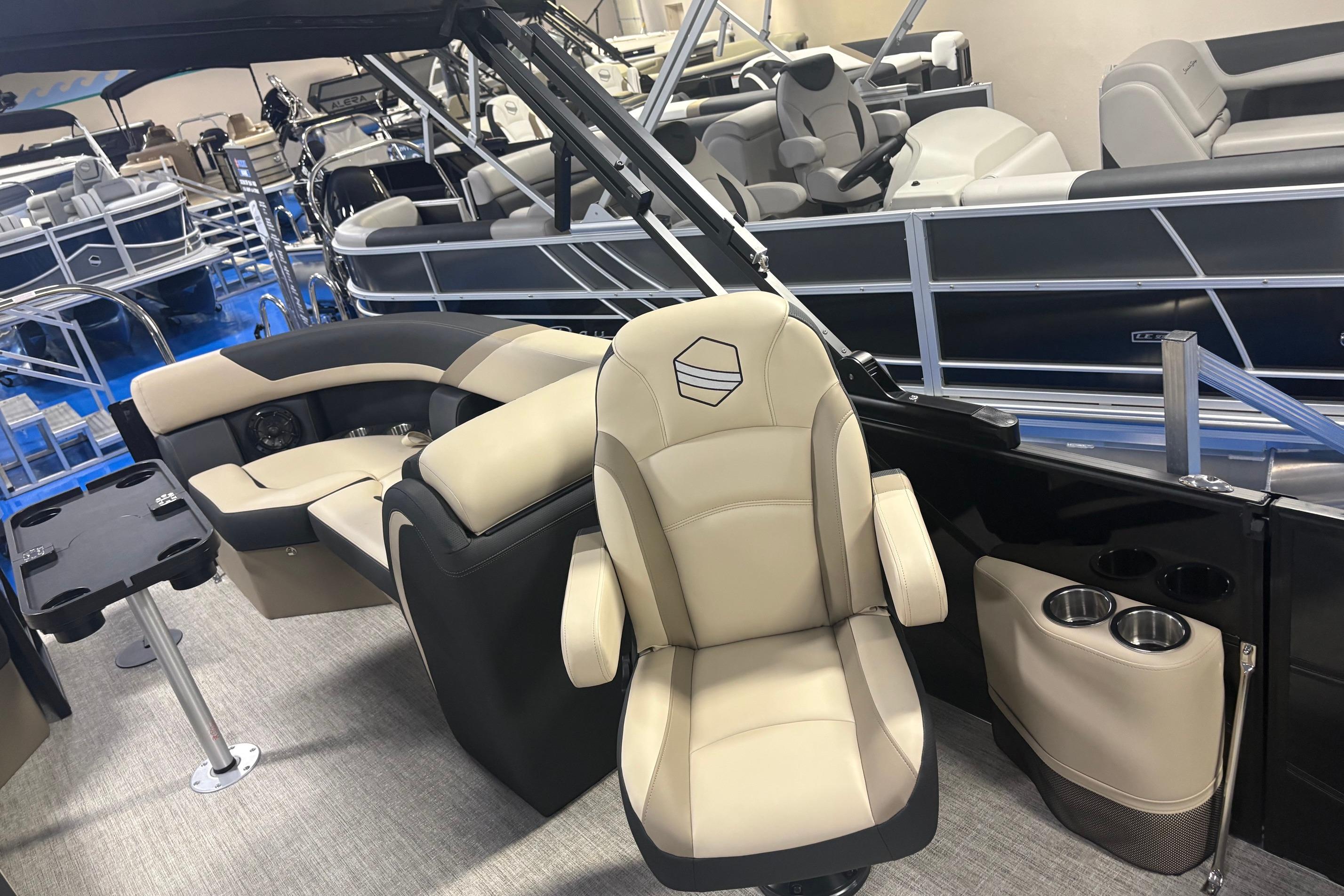 Interior of 2026 South Bay S224RS pontoon boat with beige seating and cup holders.