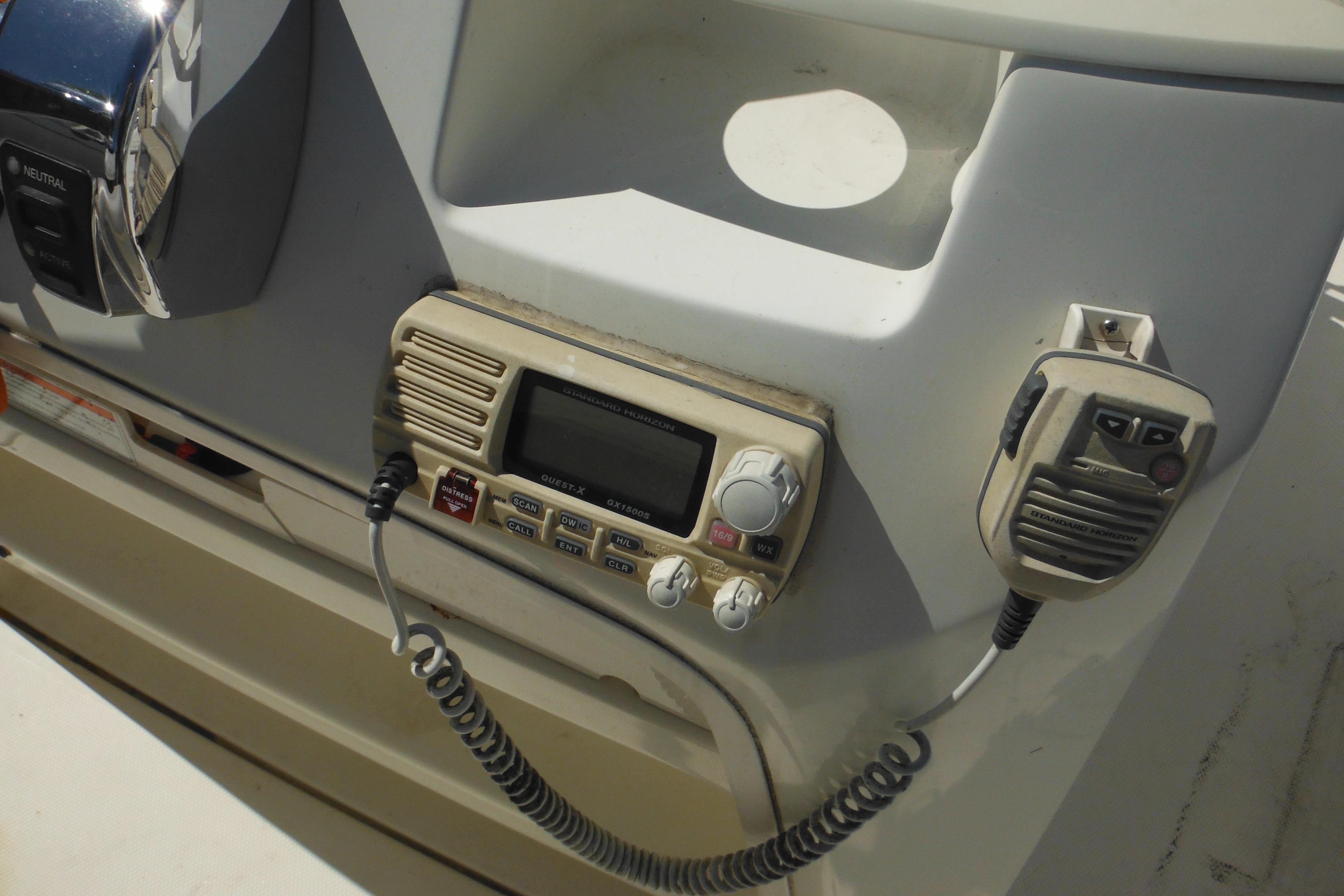 Control panel of a 2009 Boston Whaler 200 Dauntless boat with radio equipment.