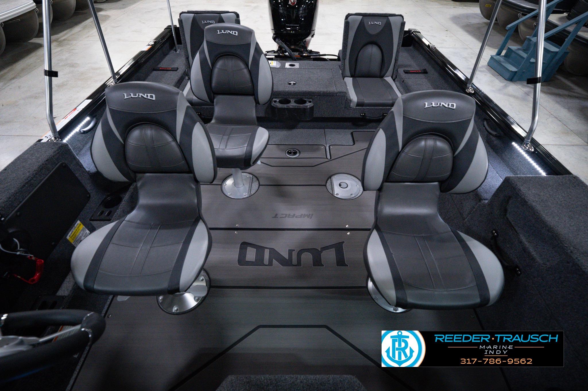 2026 Lund 1875 Impact XS SS boat interior with four gray seats and branded flooring.