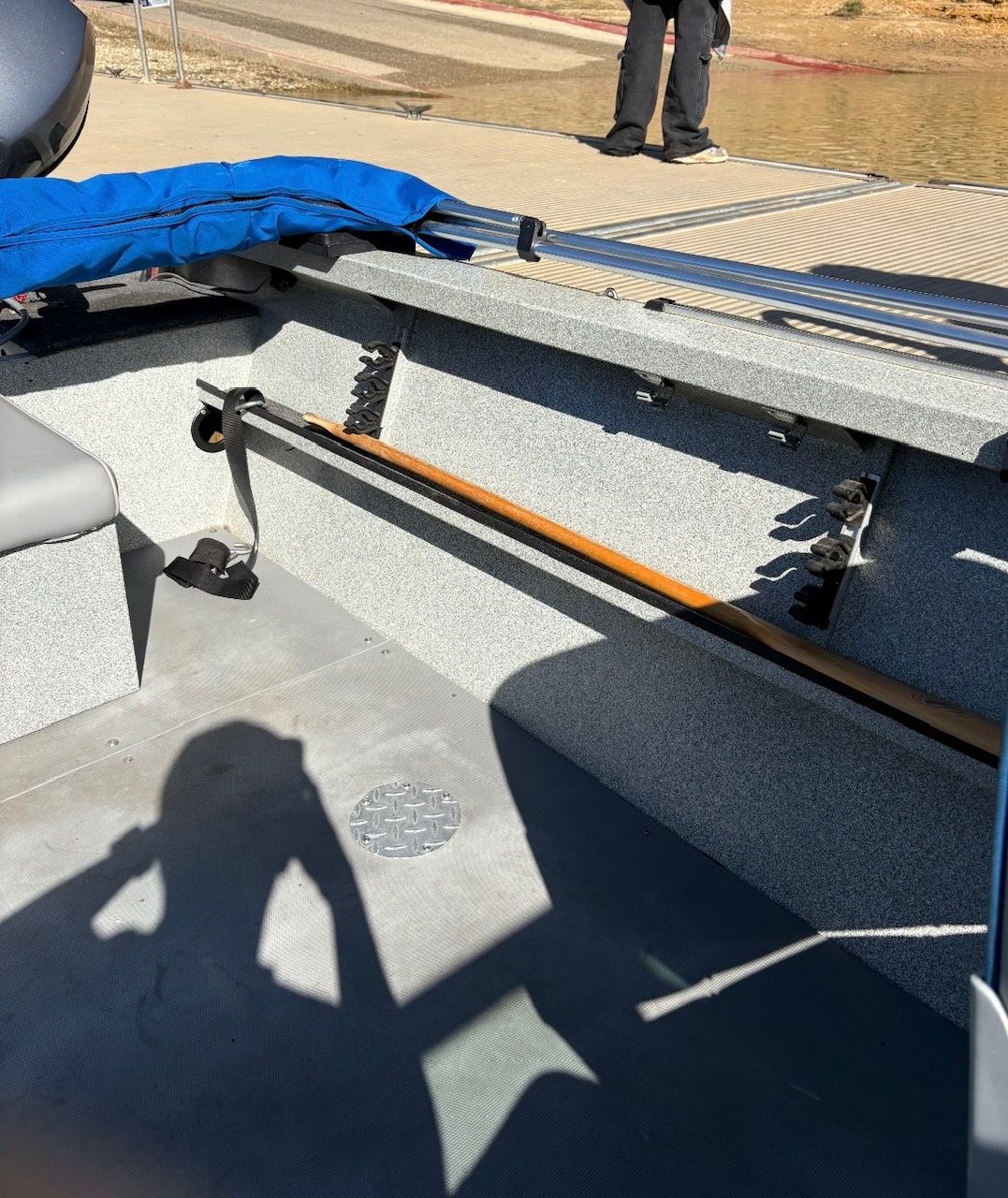 The image shows the interior of a 2002 Stryker Rogue boat with a bench seat and oar holder.