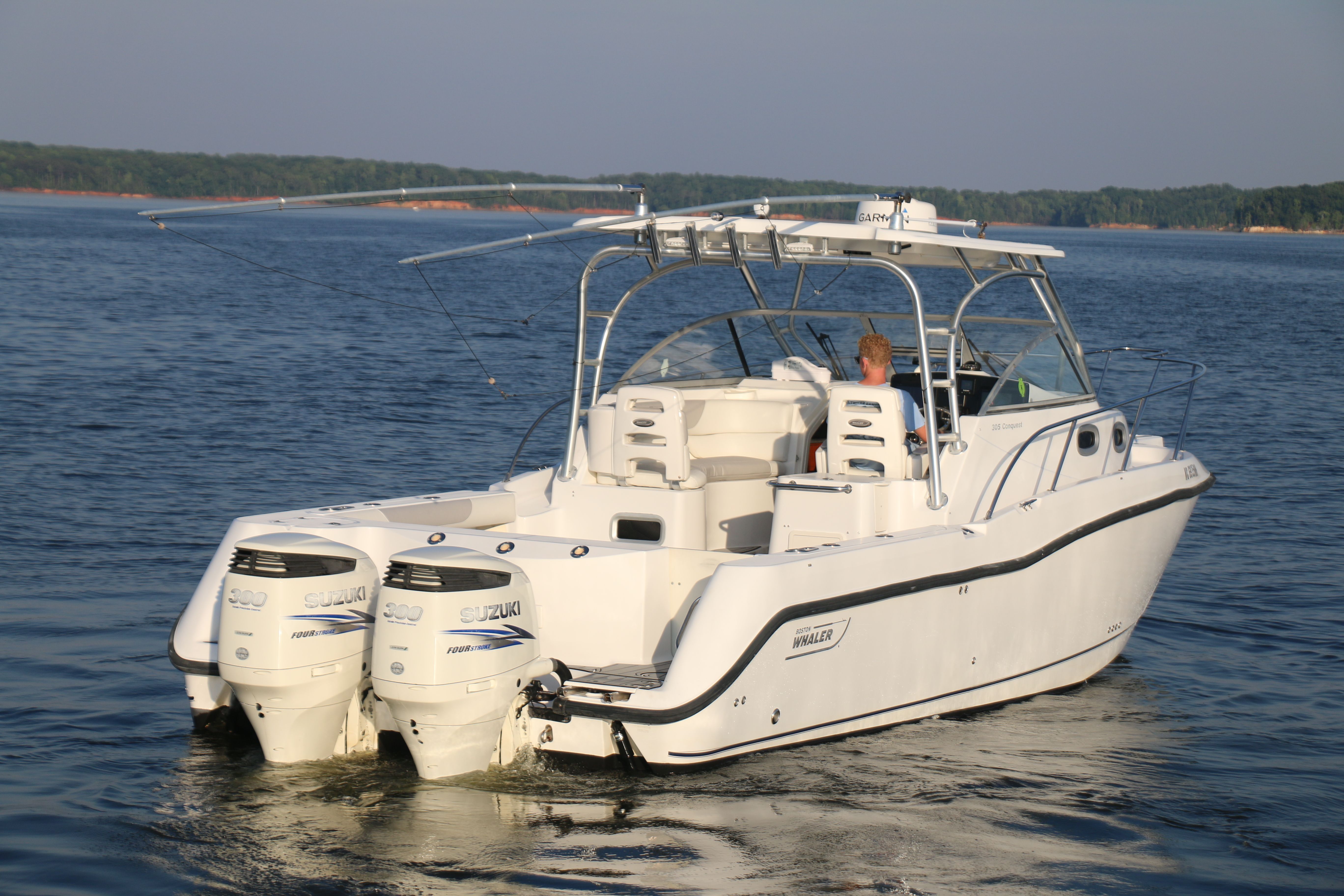 A 2006 Boston Whaler 305 Conquest cruising on calm waters.