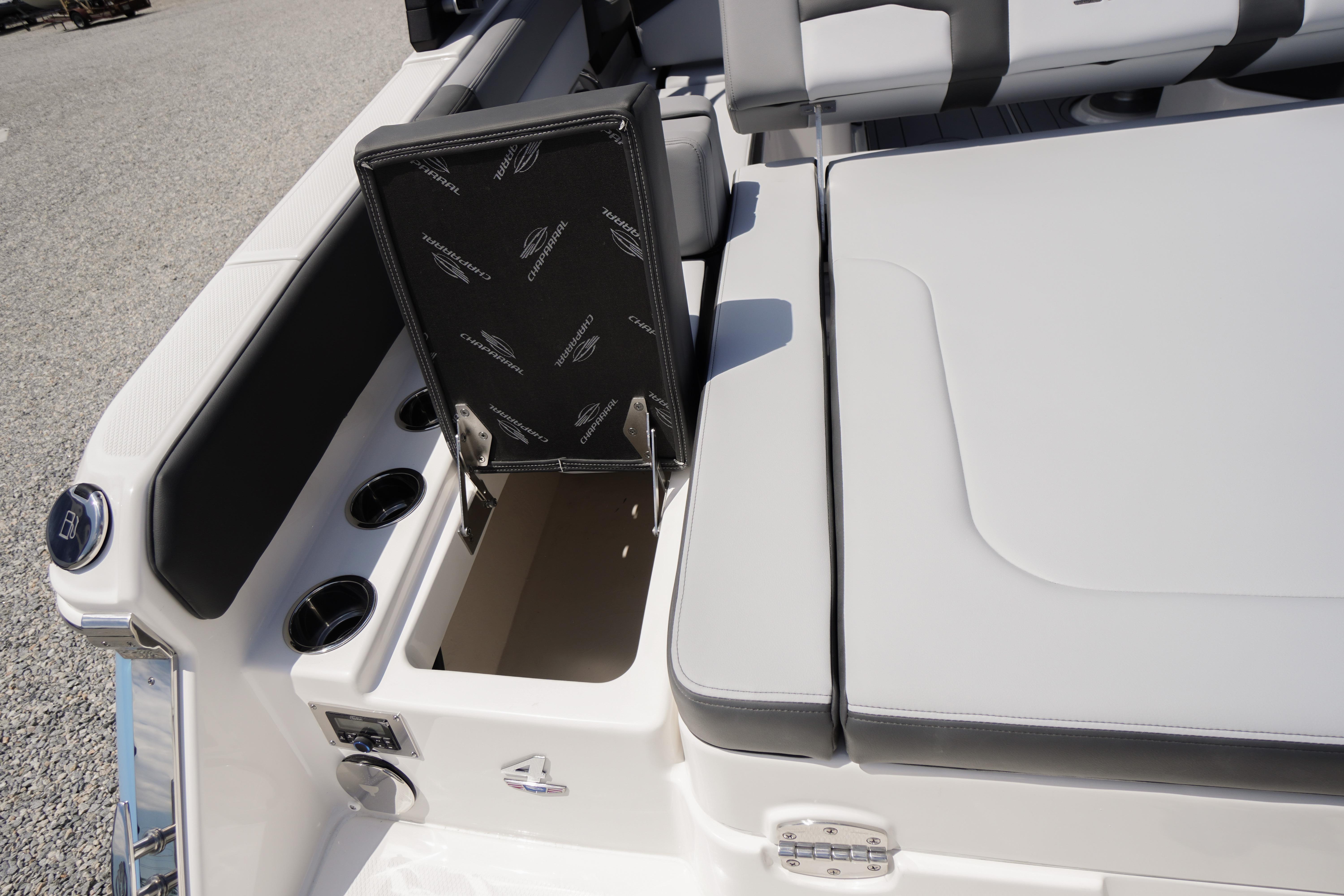 2026 Chaparral SSX 4 boat interior with open storage compartment and cup holders.