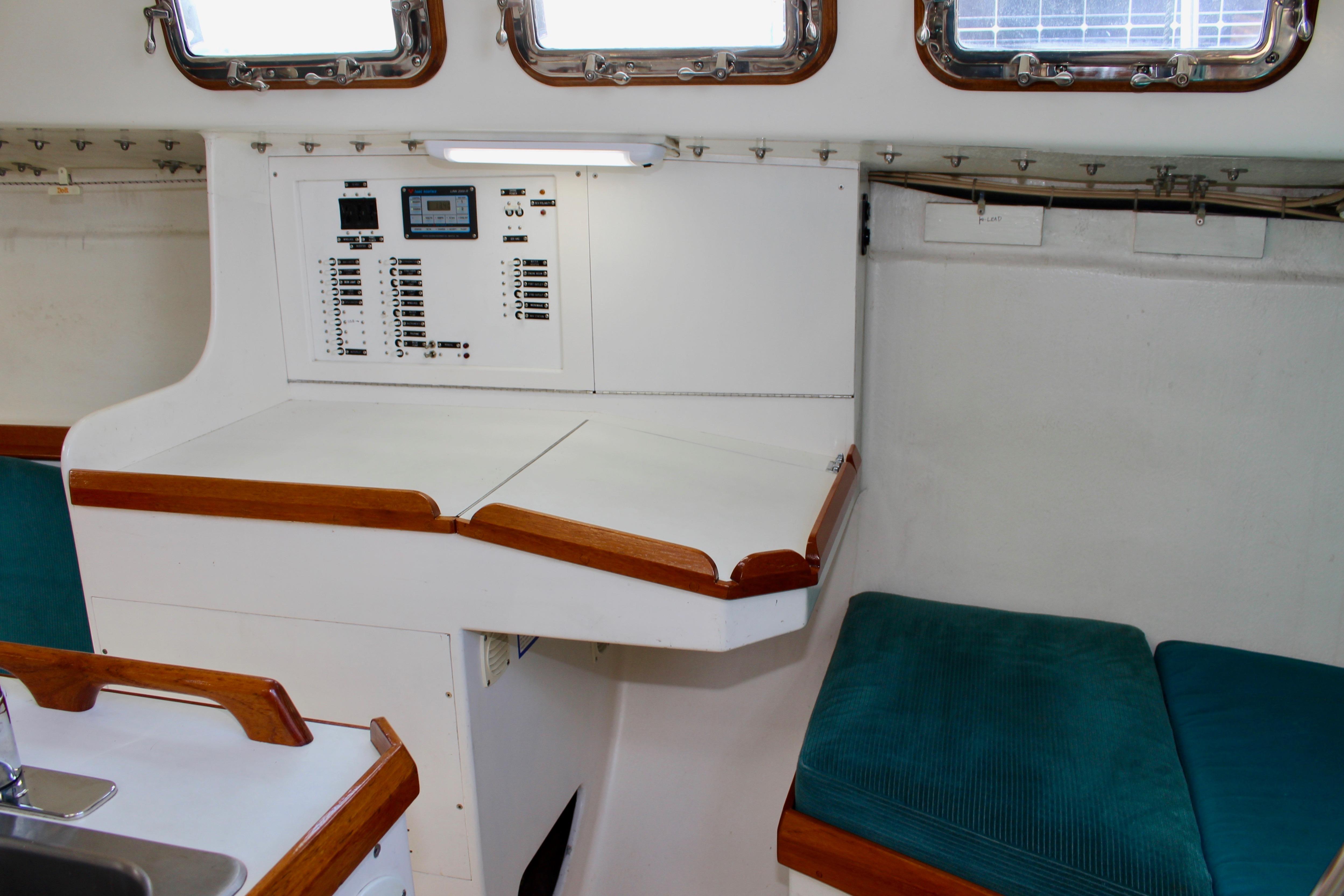 Interior of 1993 Freya 39 sailboat with control panel and teal seating.