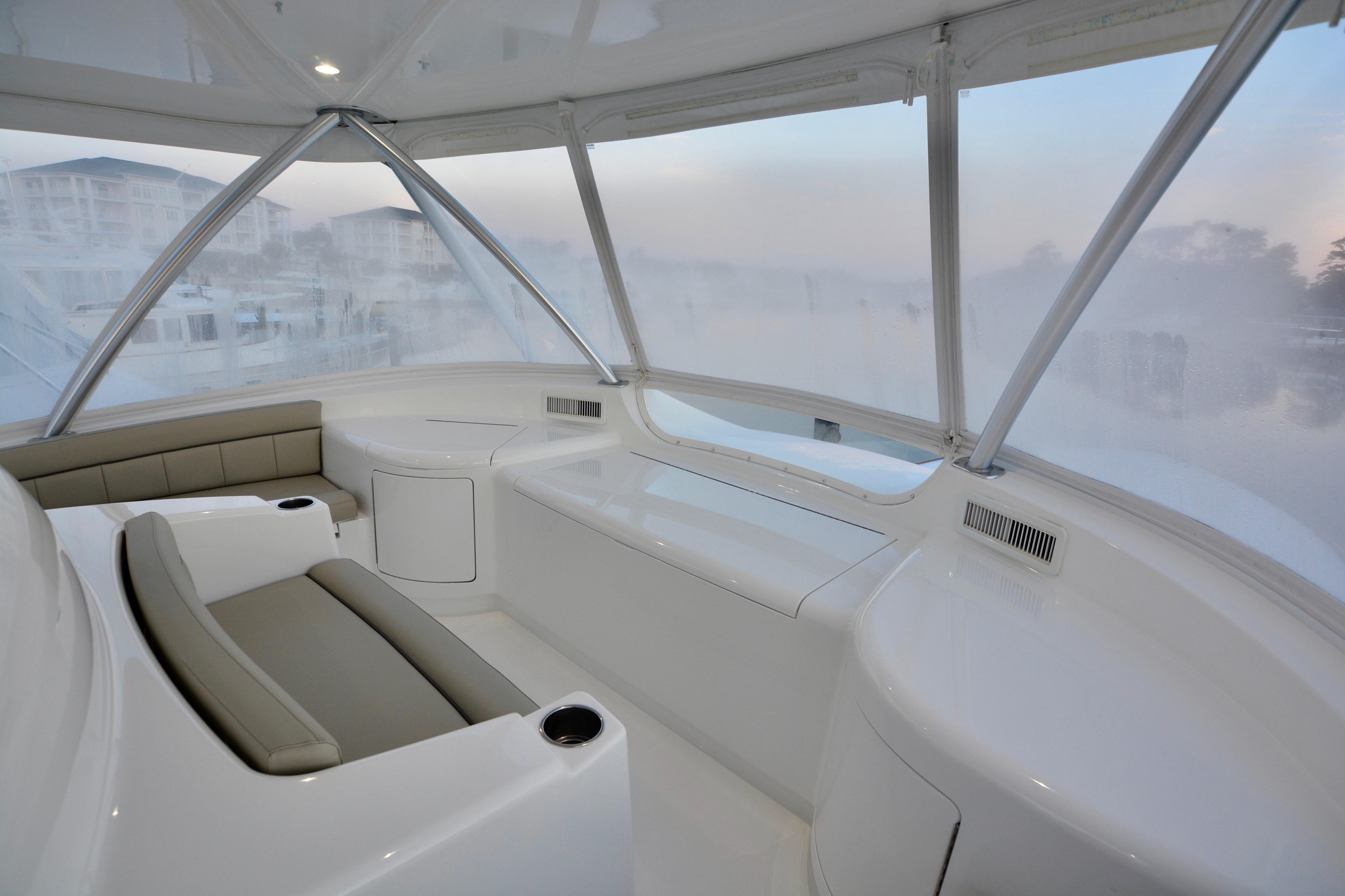 Luxurious interior of 2019 Viking 68 Convertible yacht with panoramic windows and seating.