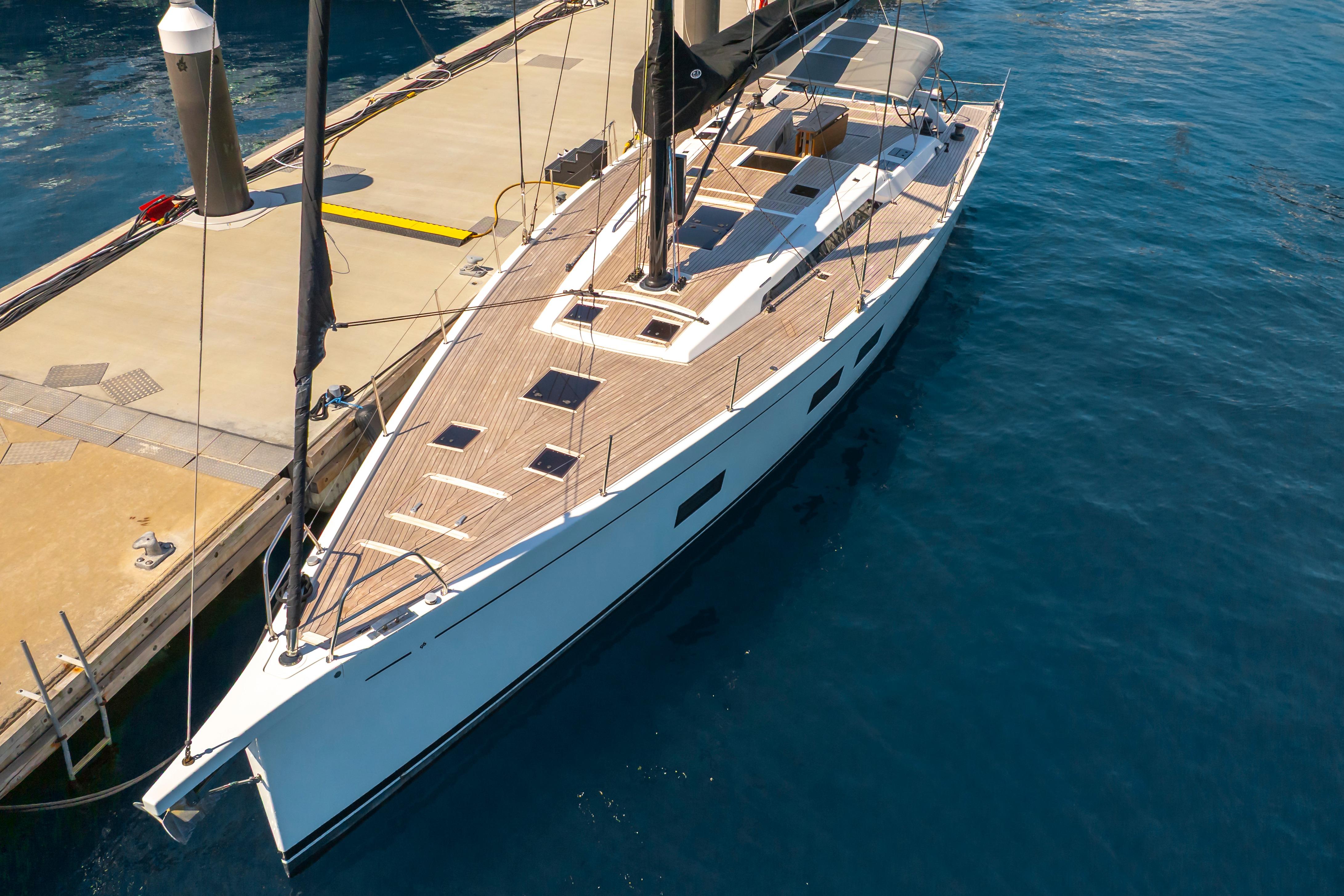 Grand Soleil 58 yacht, 2016 model, docked at marina with sleek design and wooden deck.