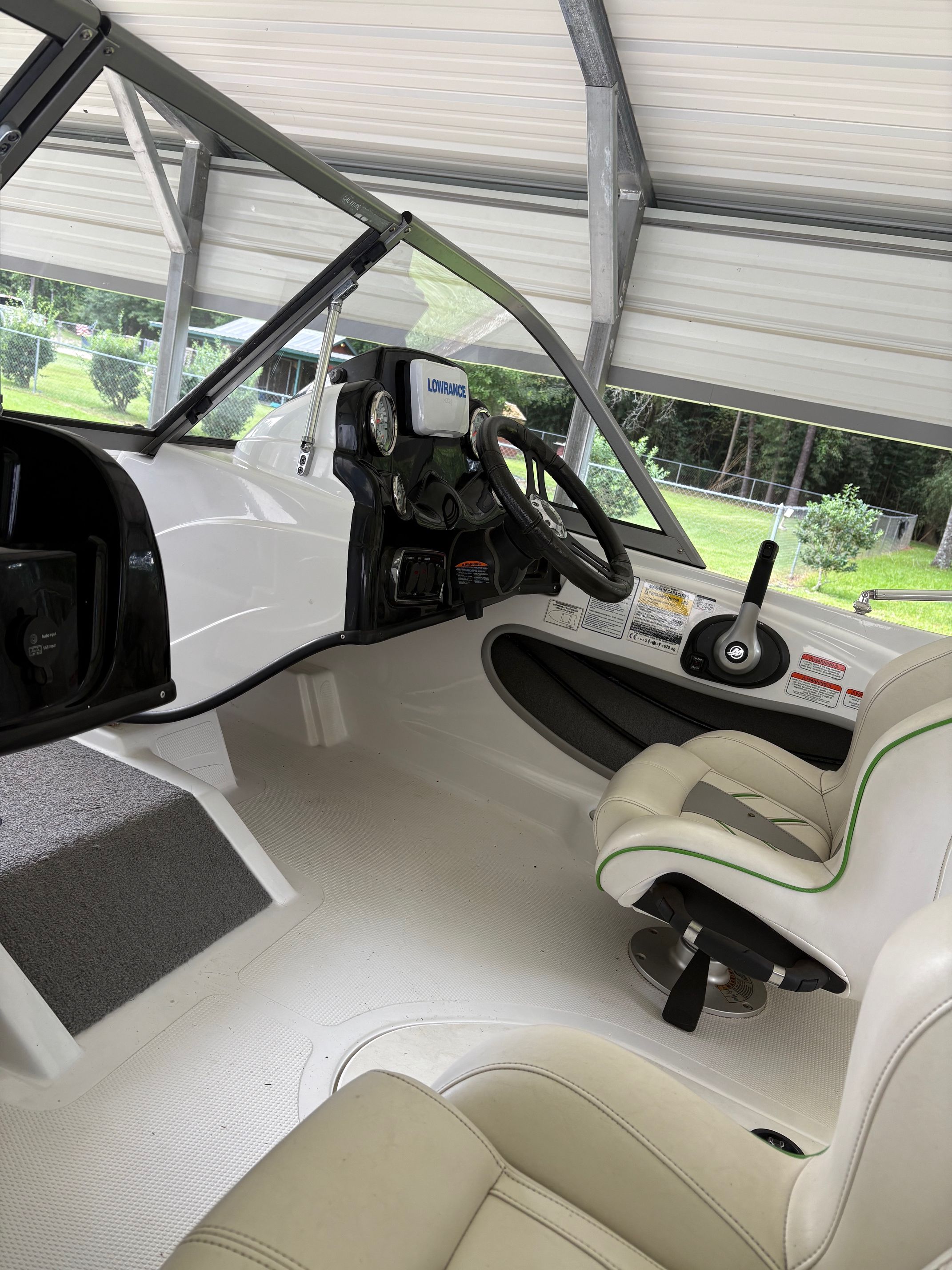 The image shows the cockpit of a 2021 Nitro Z19 Sport boat with a steering wheel and instruments.