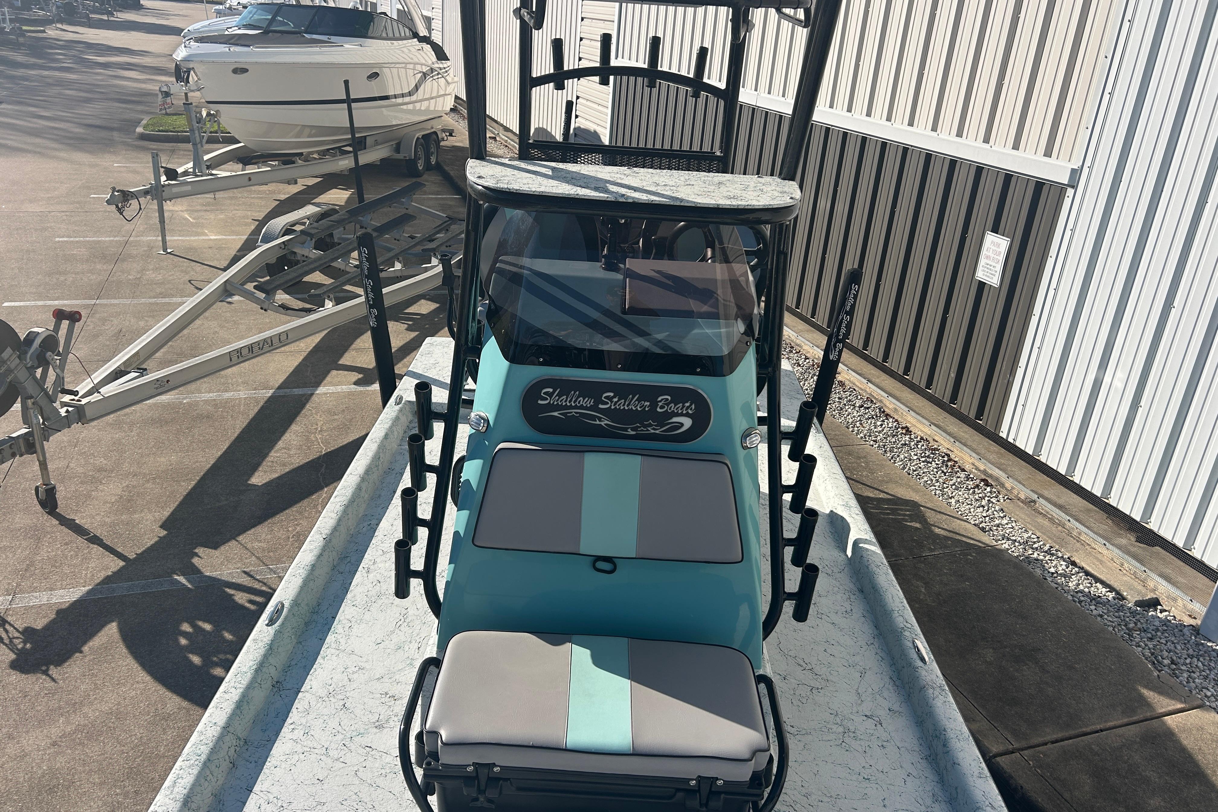 2021 Shallow Stalker Cat 240 Pro Elite boat in a parking lot, front view.