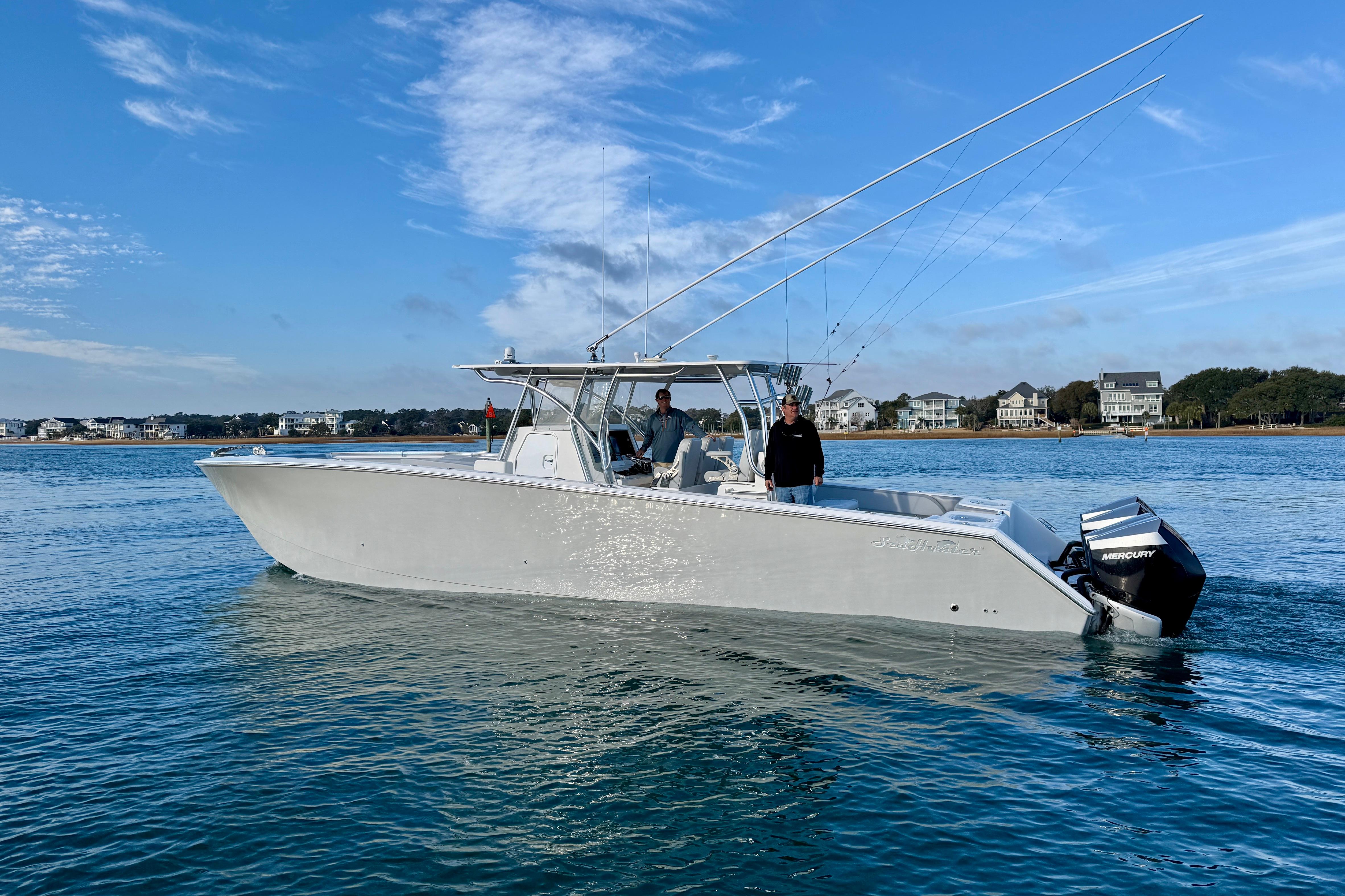 2021 SeaHunter 41 CTS boat on calm water with two people onboard.