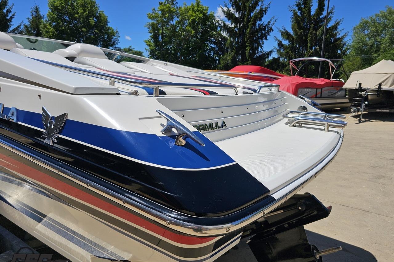 2005 Formula 271 FASTech boat with sleek design, parked outdoors on a sunny day.
