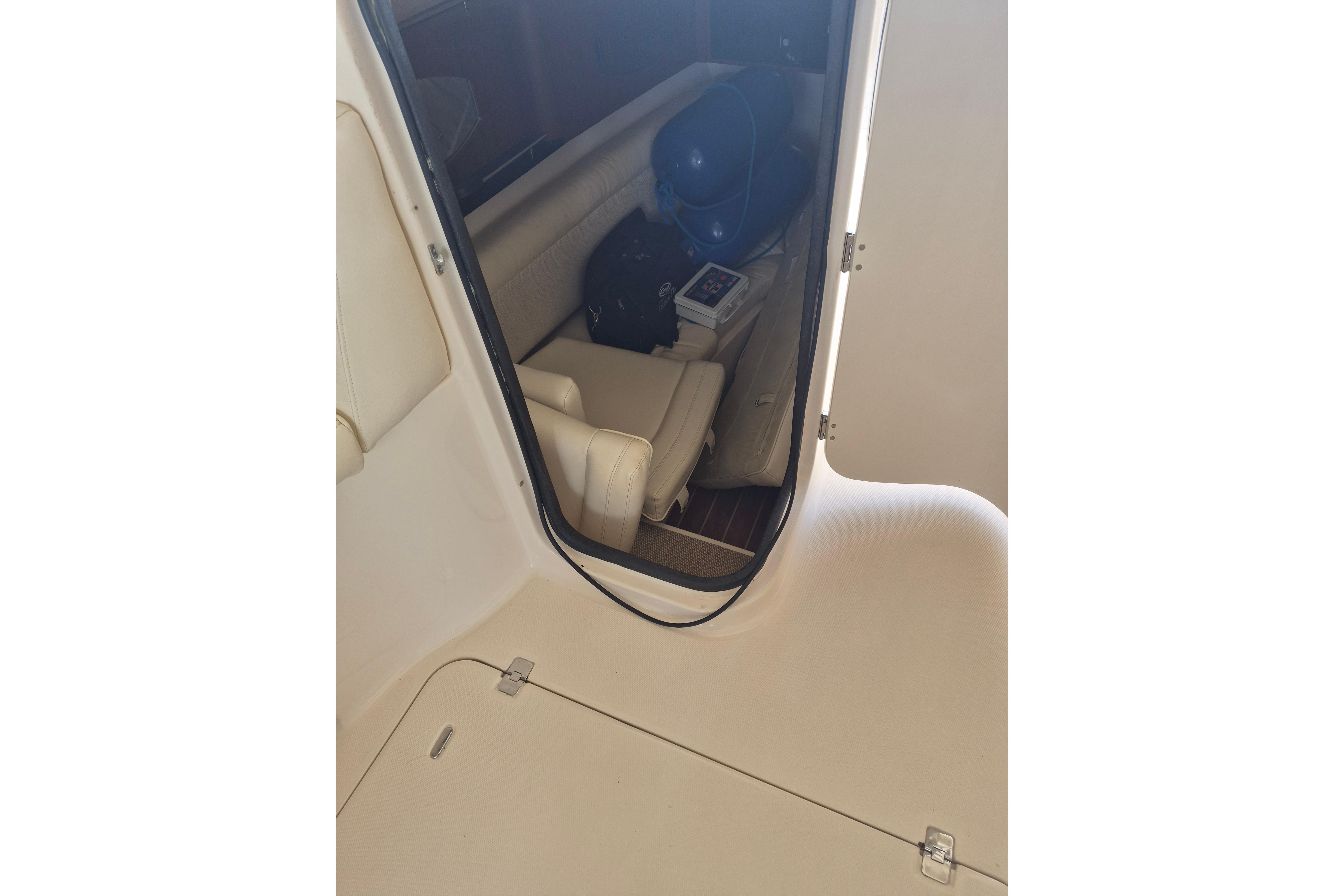 Interior view of 2019 Grady-White Freedom 335 boat cabin with seating and equipment.