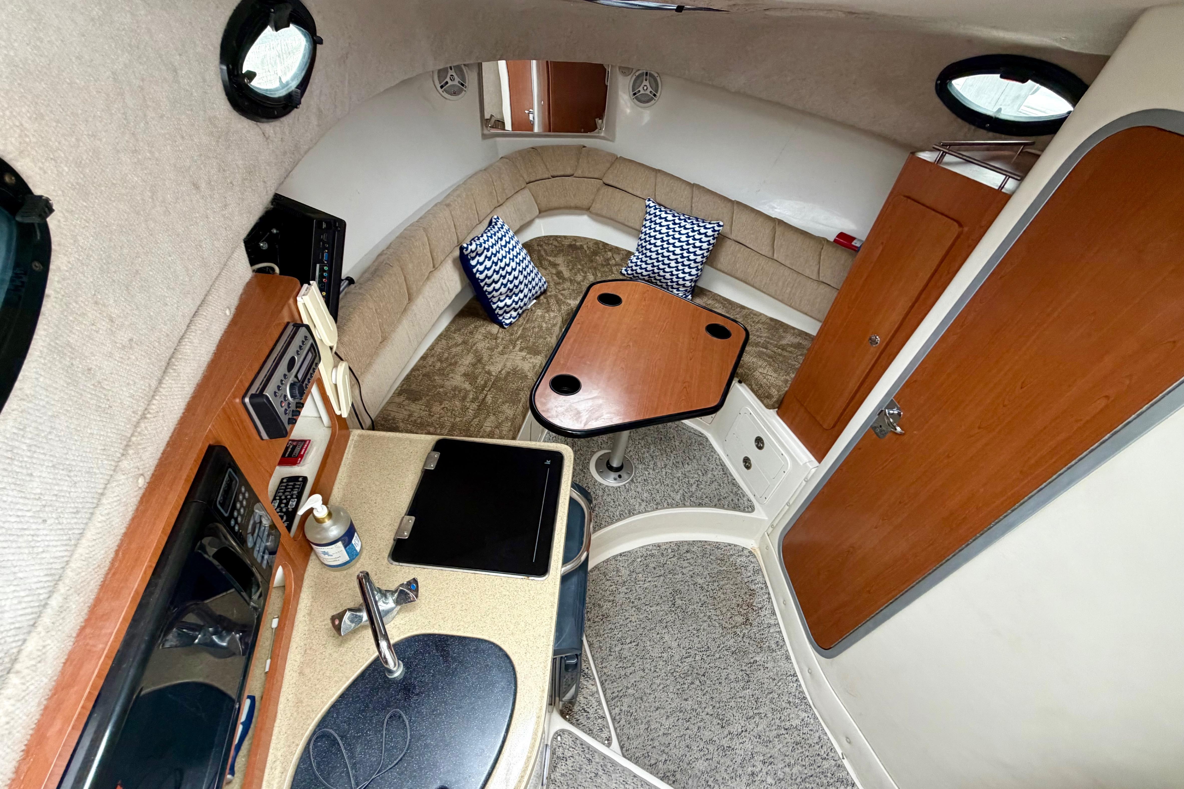 2006 Seaswirl Striper 2901 Walkaround O/B cabin interior with kitchenette and seating area.