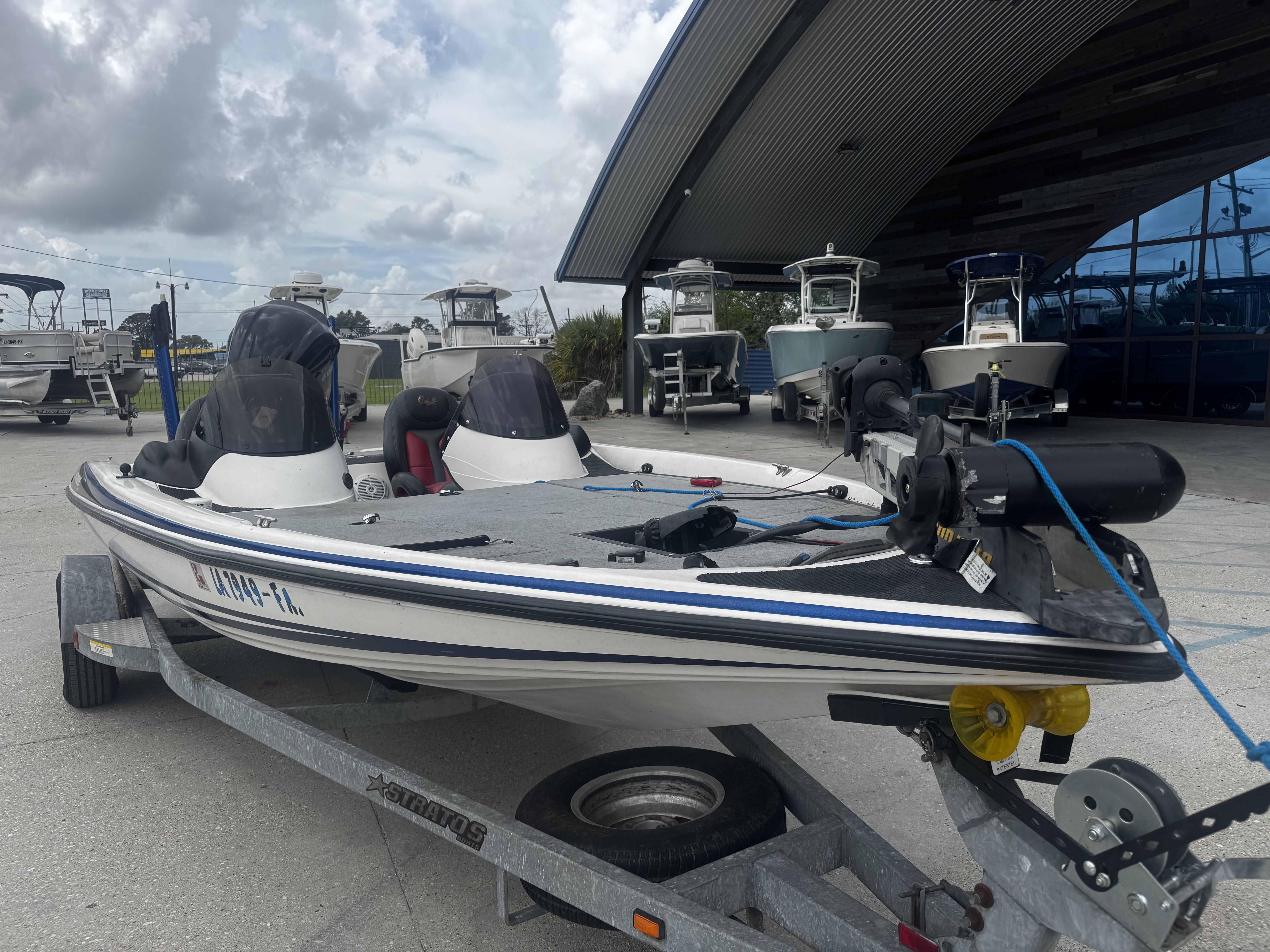 2006 Stratos 285 Pro XL boat on trailer outside showroom.