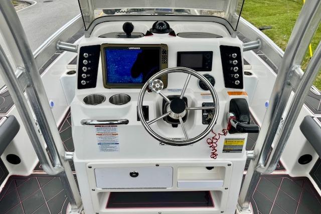 2015 Robalo 226 Cayman boat dashboard with steering wheel and navigation system.
