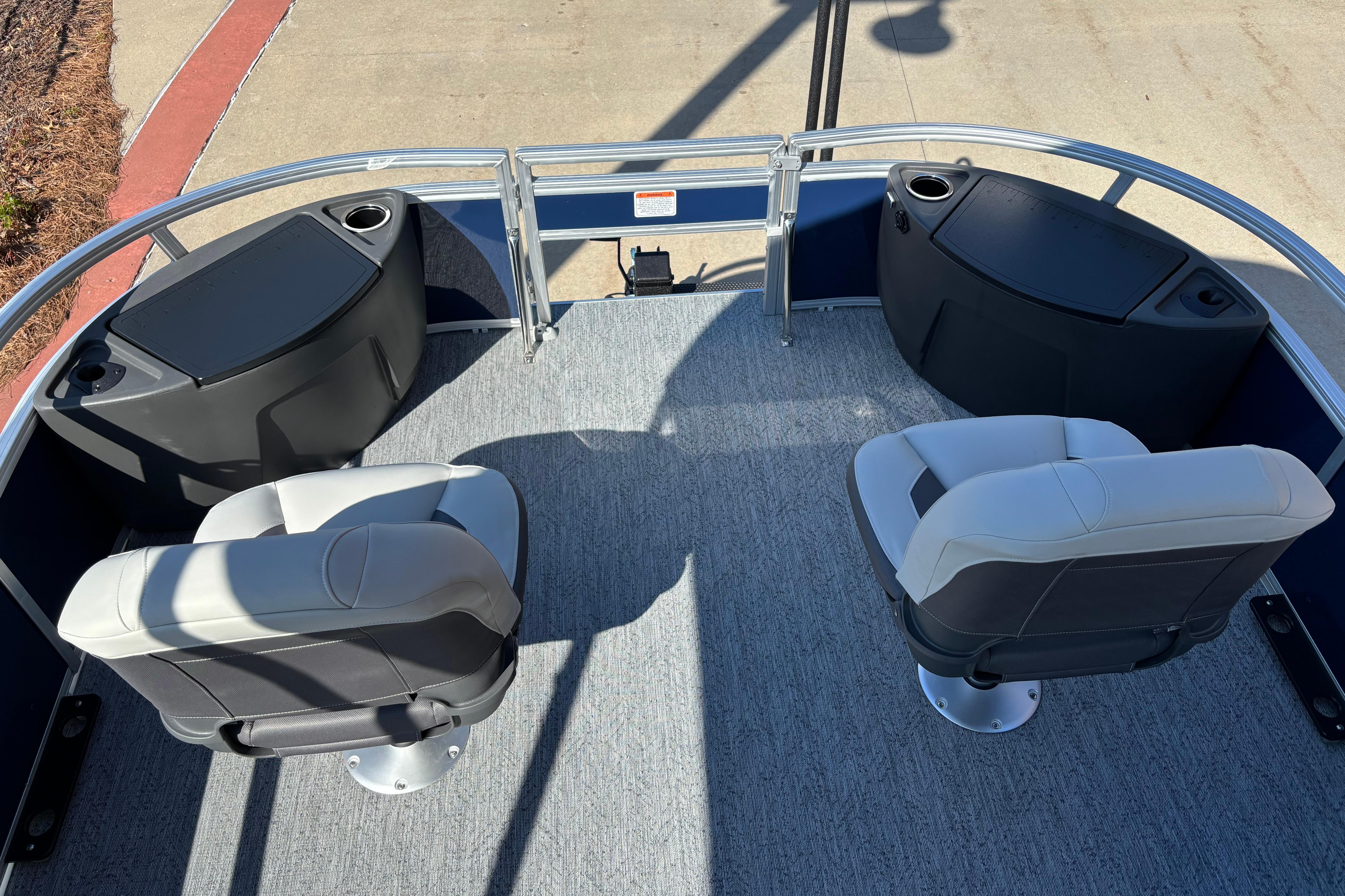 2026 Sun Tracker Bass Buggy 18 DLX pontoon boat interior with seating and storage compartments.