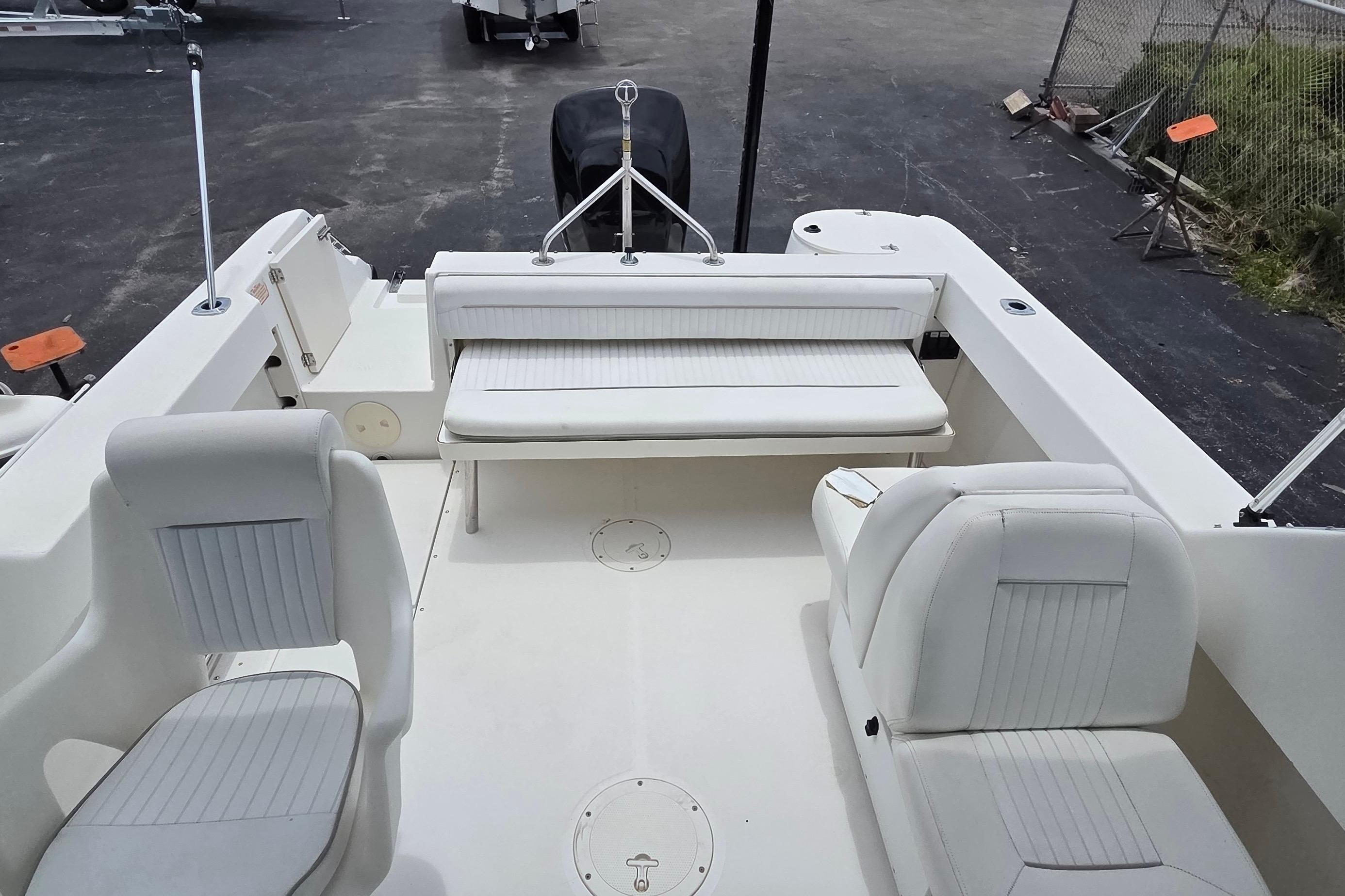 2000 Boston Whaler 21 Ventura boat interior with white seating and spacious deck layout.