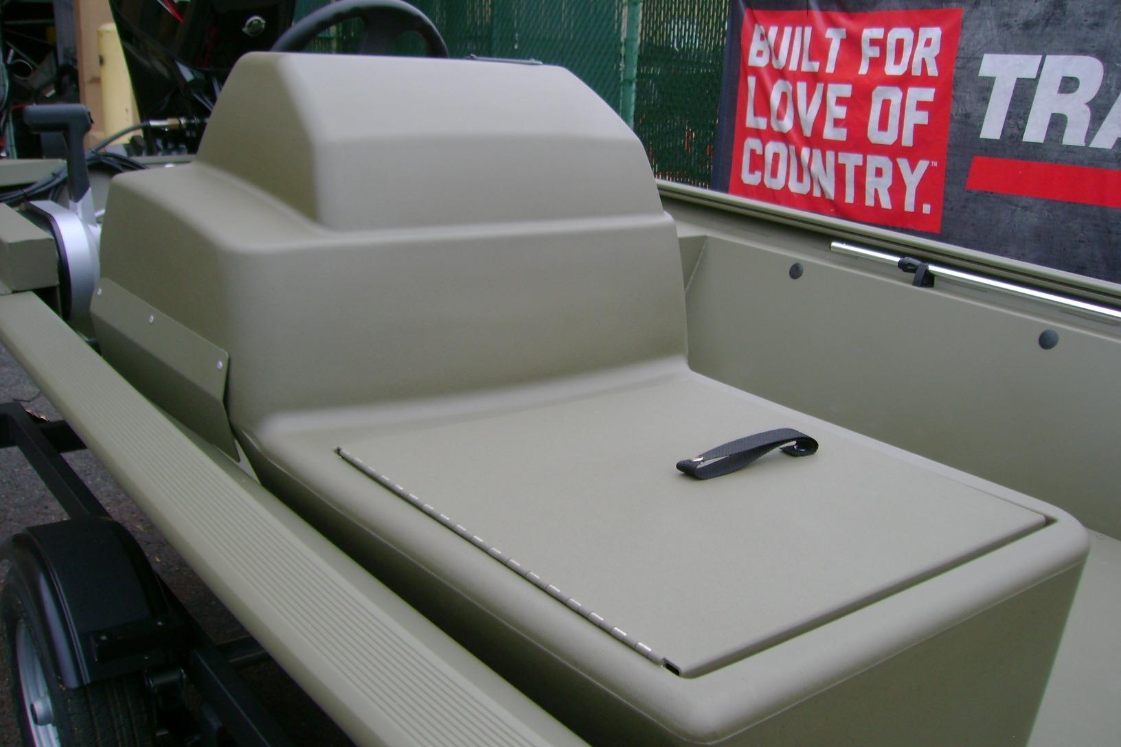 2026 Tracker Grizzly 1648 SC boat interior with storage compartment and steering console.