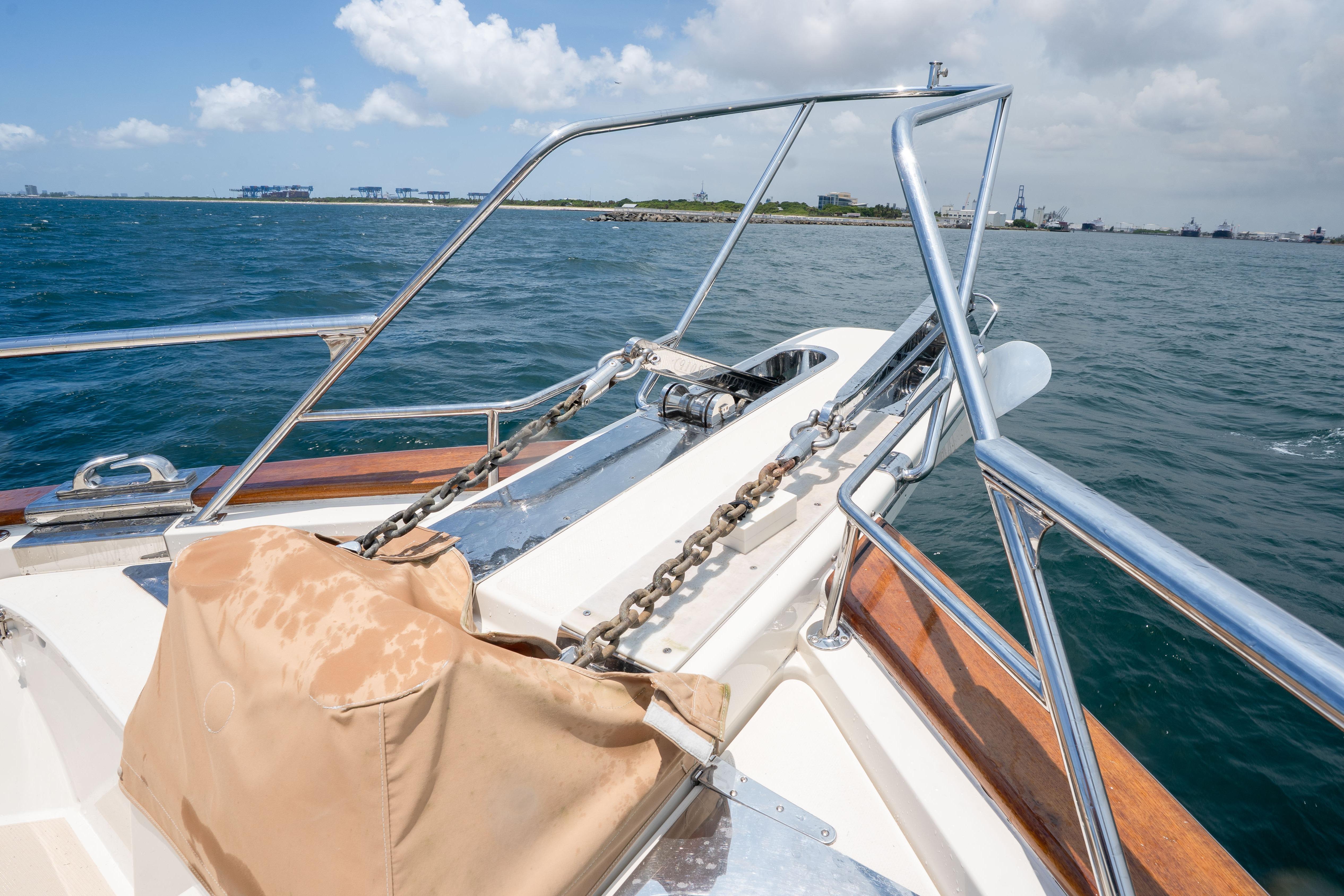 Bow of 2006 Fleming 75 yacht with anchor chain, ocean view, and clear sky.