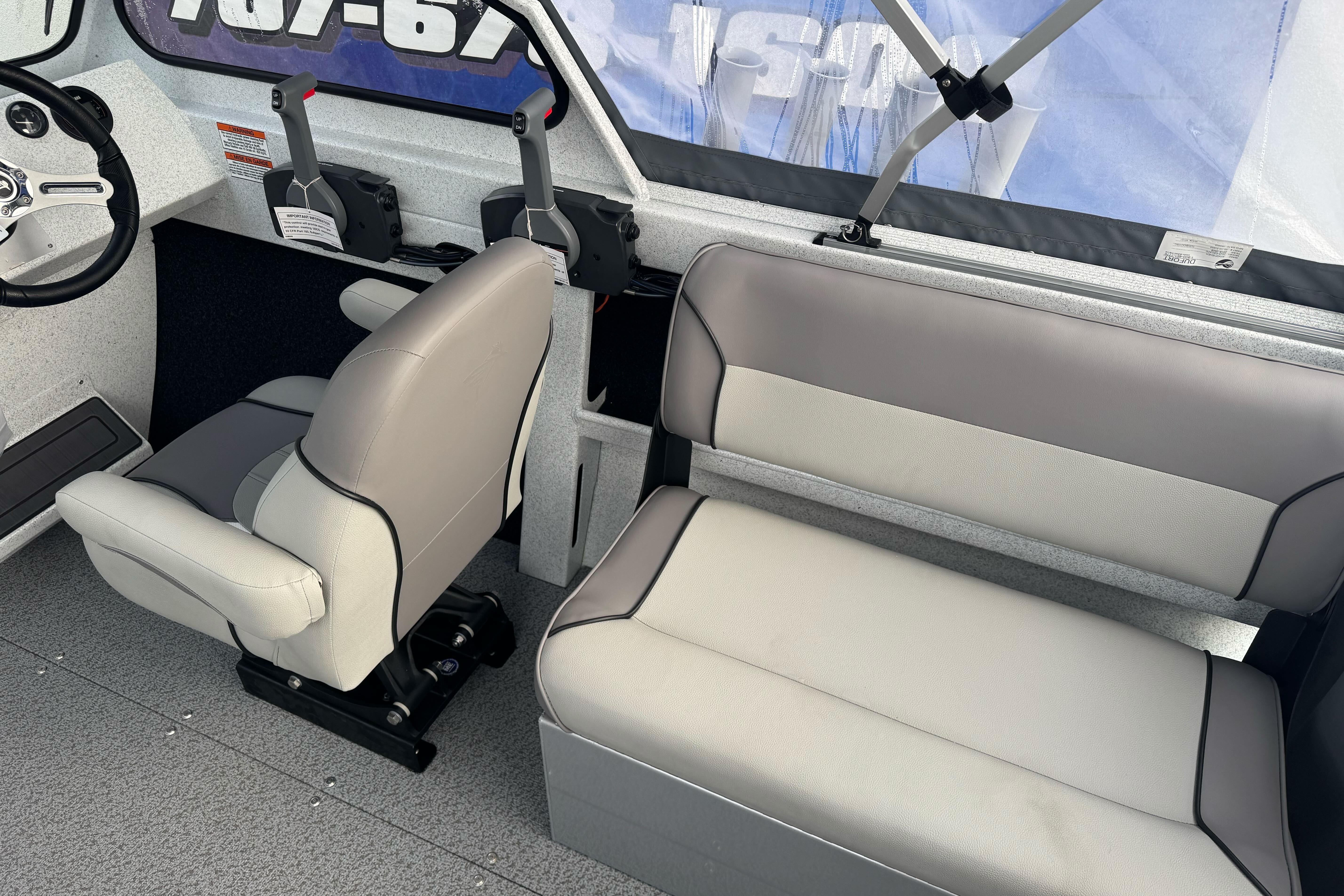 Interior of 2026 KingFisher 2025 Escape boat with seating and steering wheel.