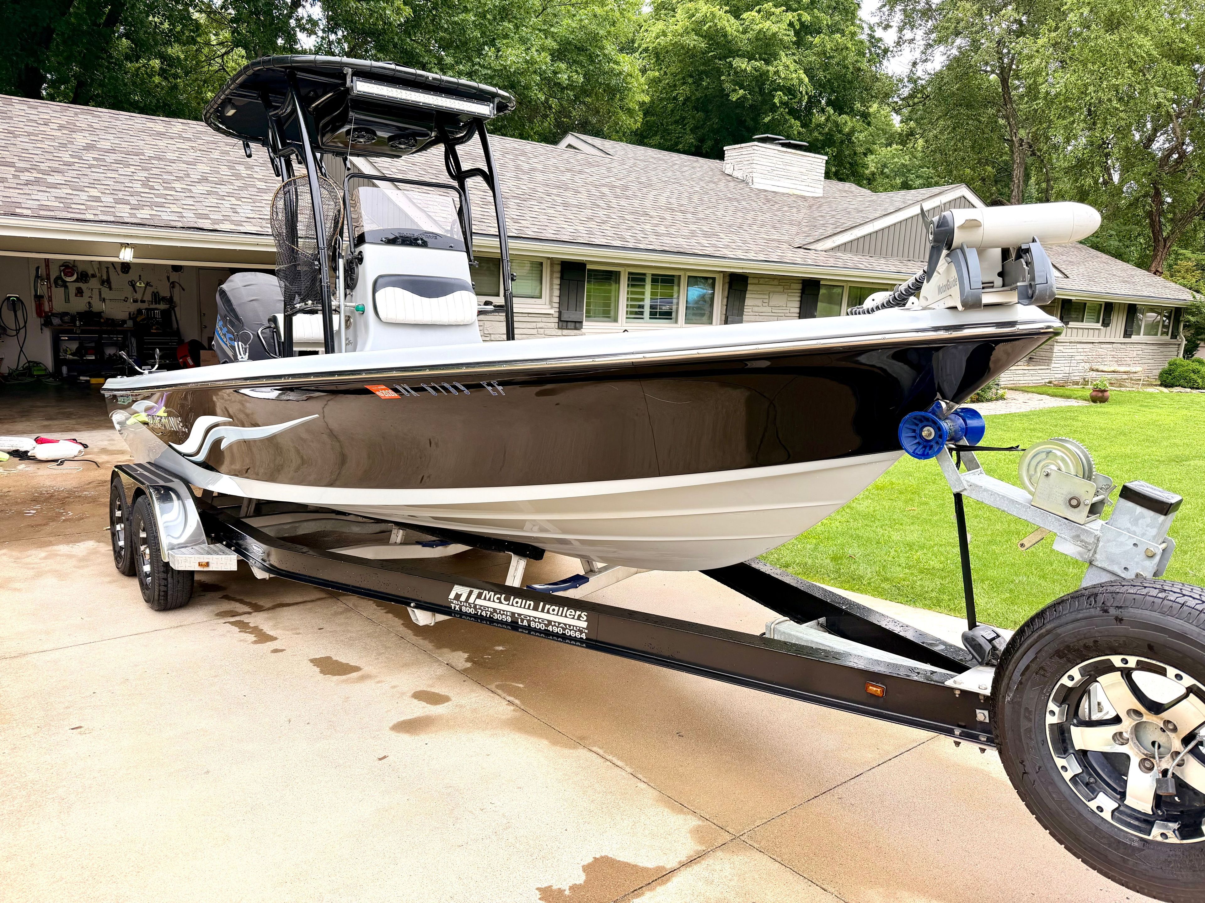 2013 Blue Wave Pure Bay 2200 on a trailer in front of a house.