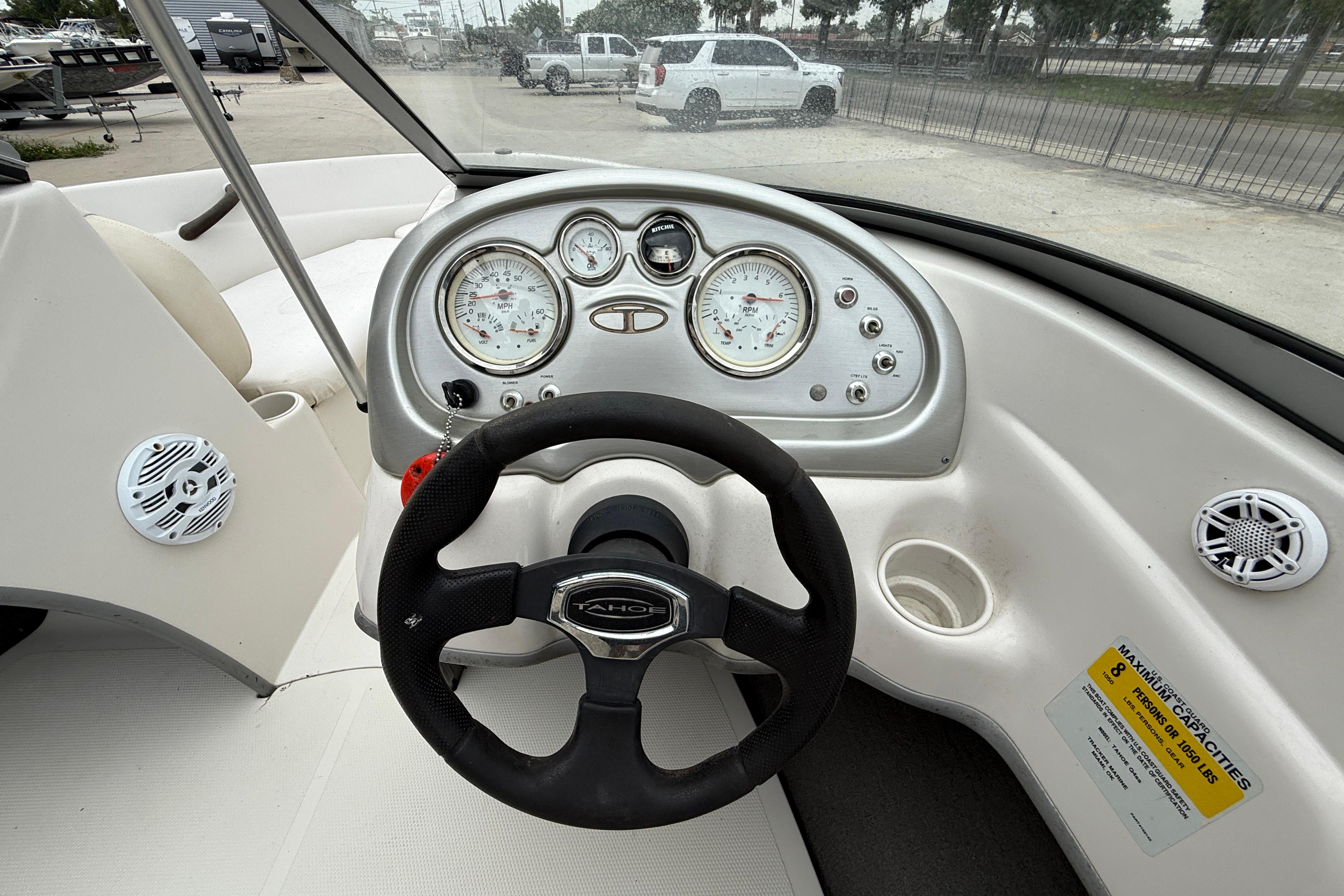 Steering wheel and dashboard of a 2010 Tahoe Q4 boat, featuring gauges and controls.