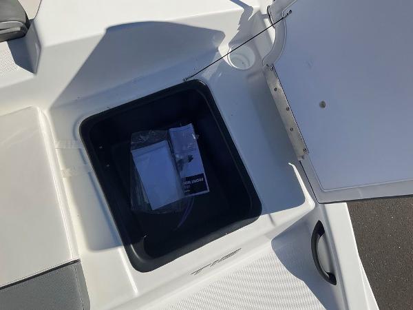 Open storage compartment on 2025 Tahoe T18 boat deck.